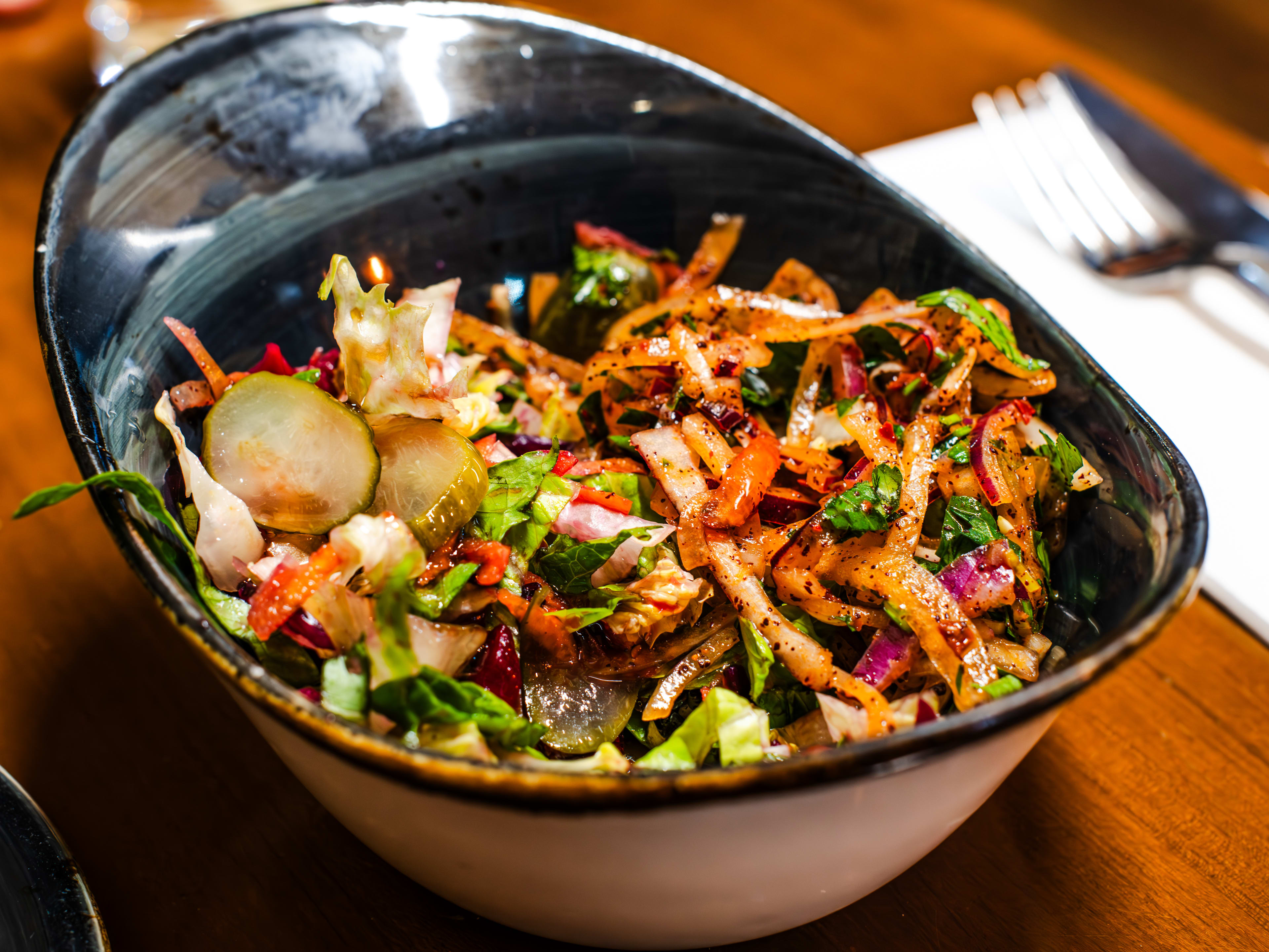 Salad with onions, pickles and lettuce.