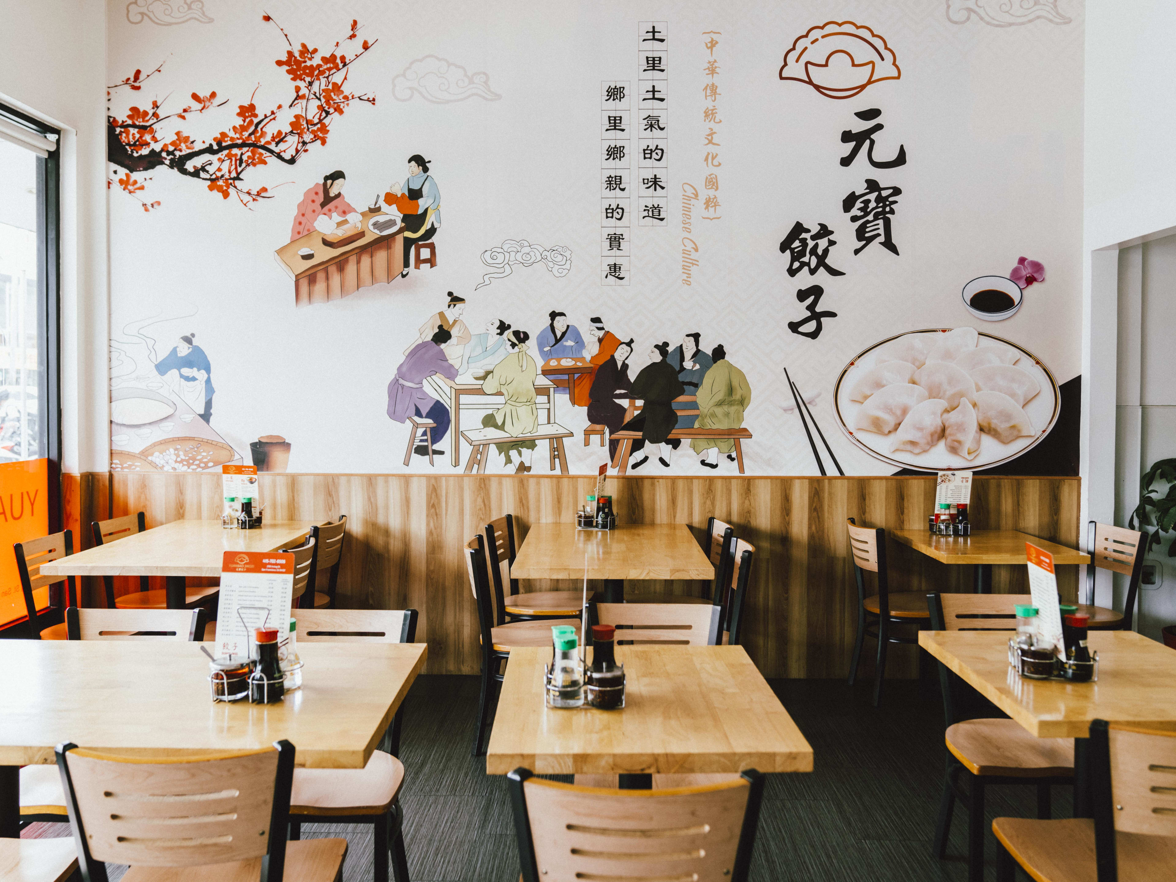 The interior mural and tables at Yuanbao Jiaozi