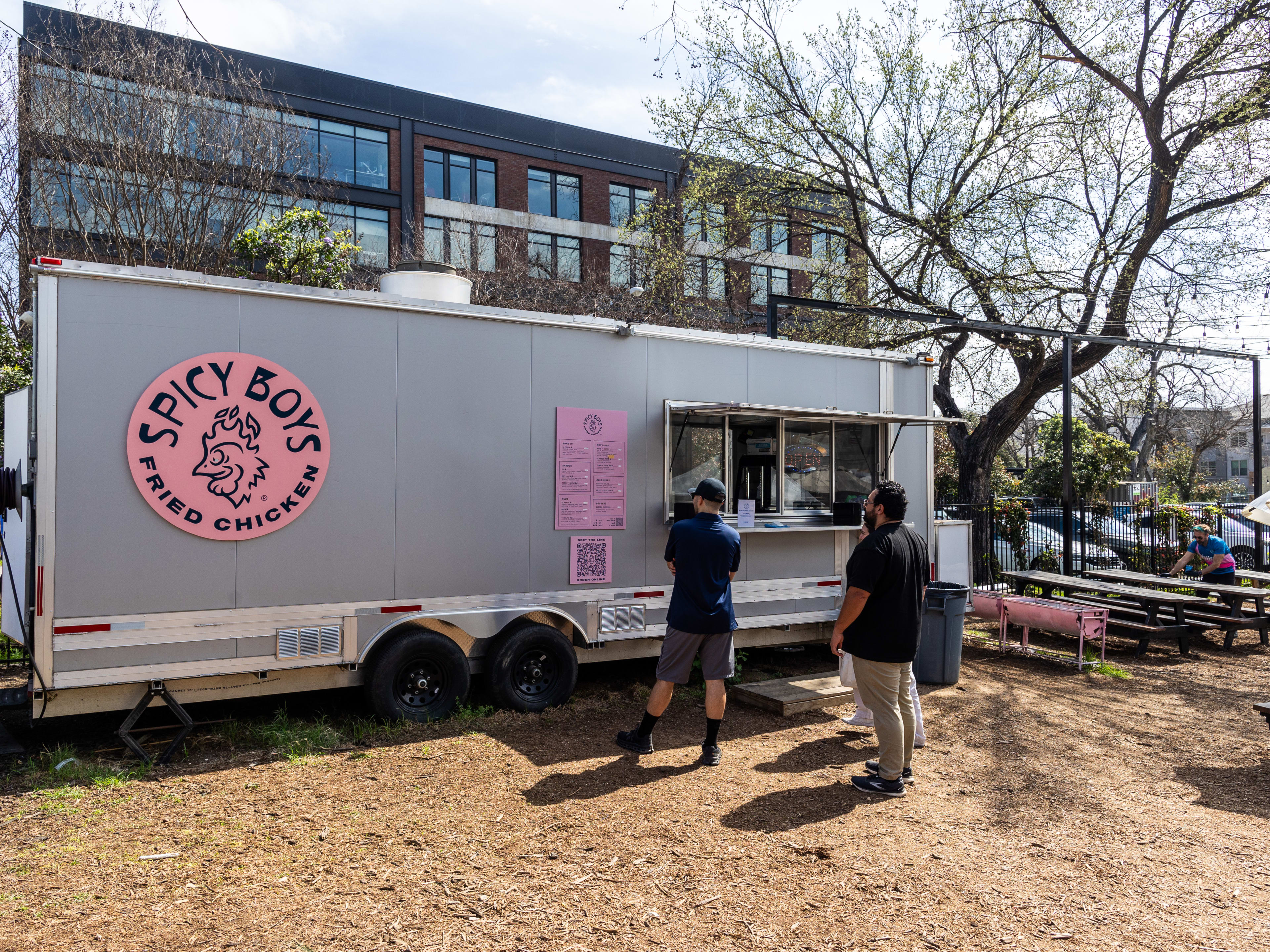 People stand in line to order at Spice Boys food truck.