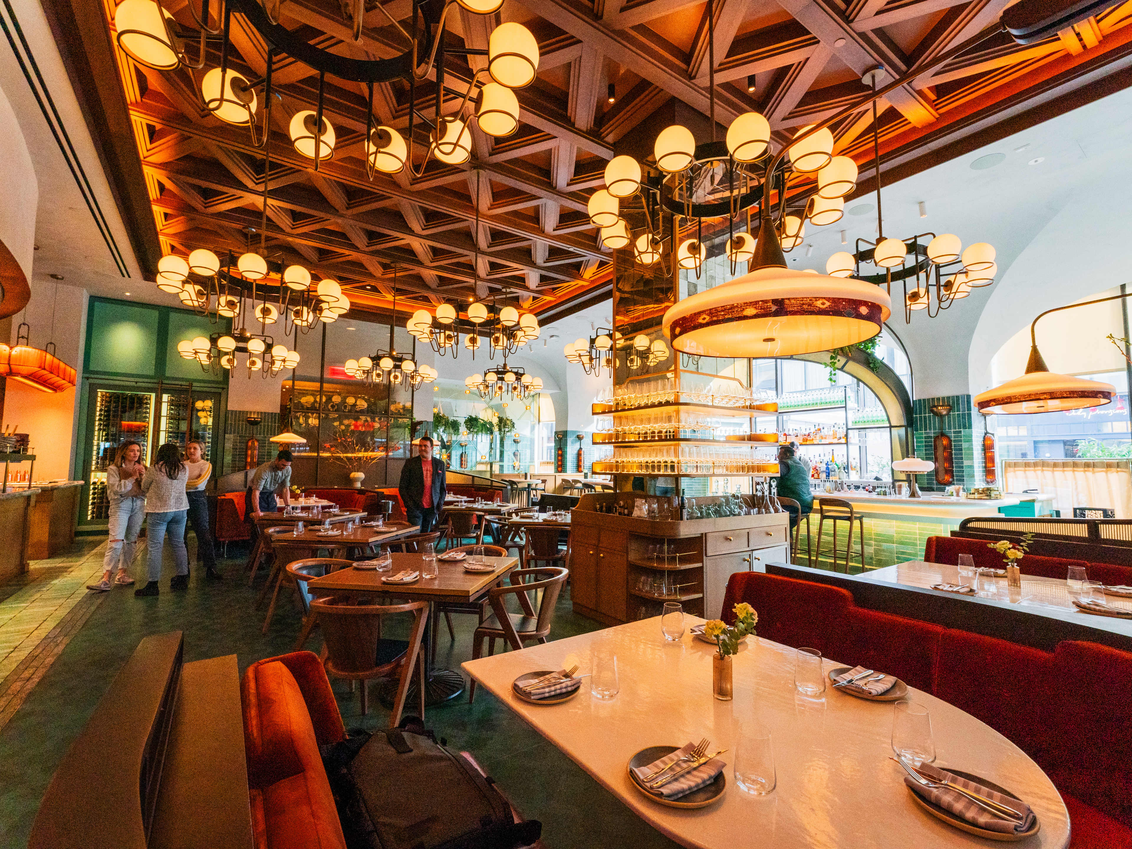 The large interior of Zou Zou's. With tables and booth seats and large hanging lights.