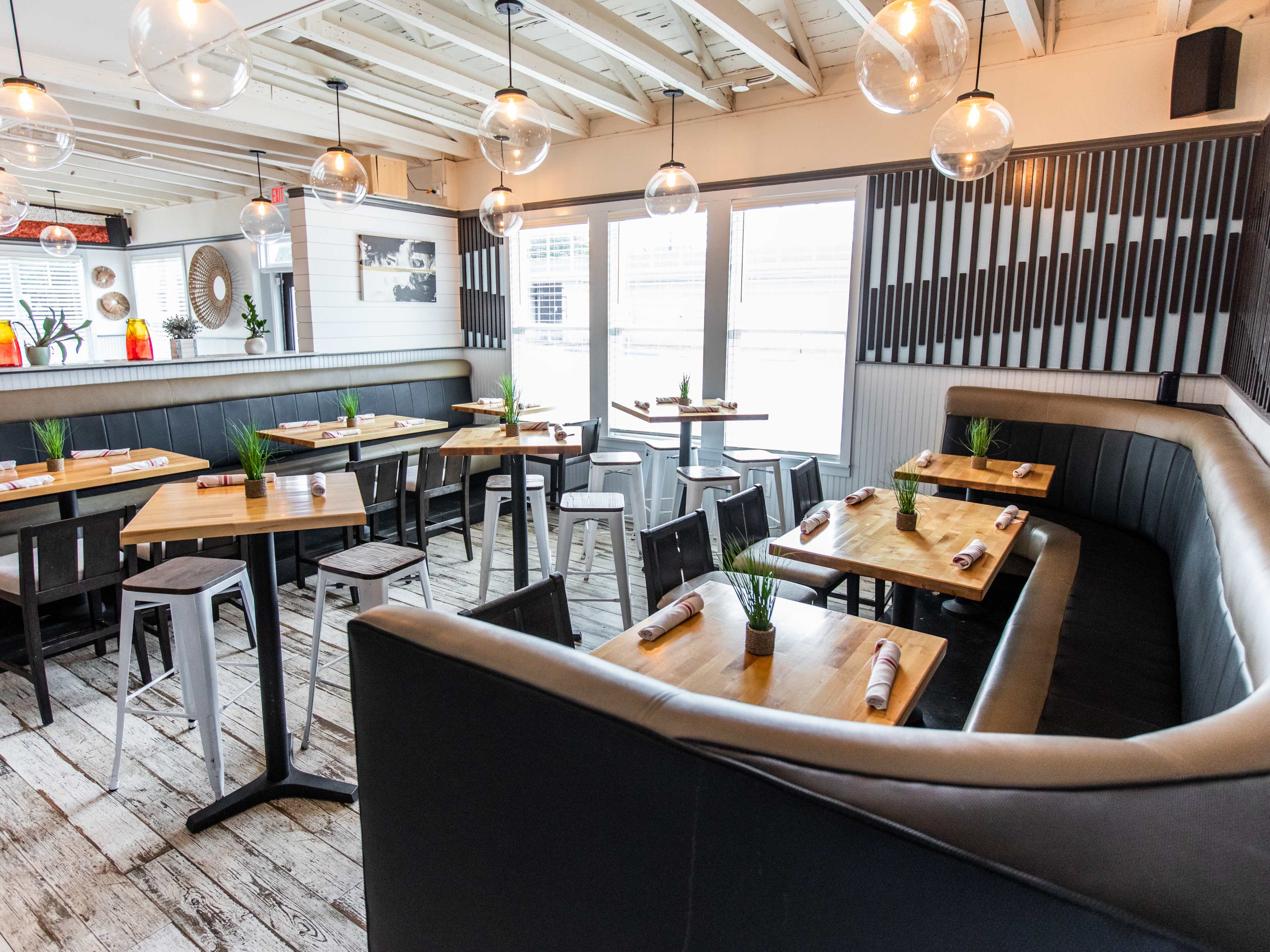 farmhouse rustic restaurant interior with a large, upshped tufted booth