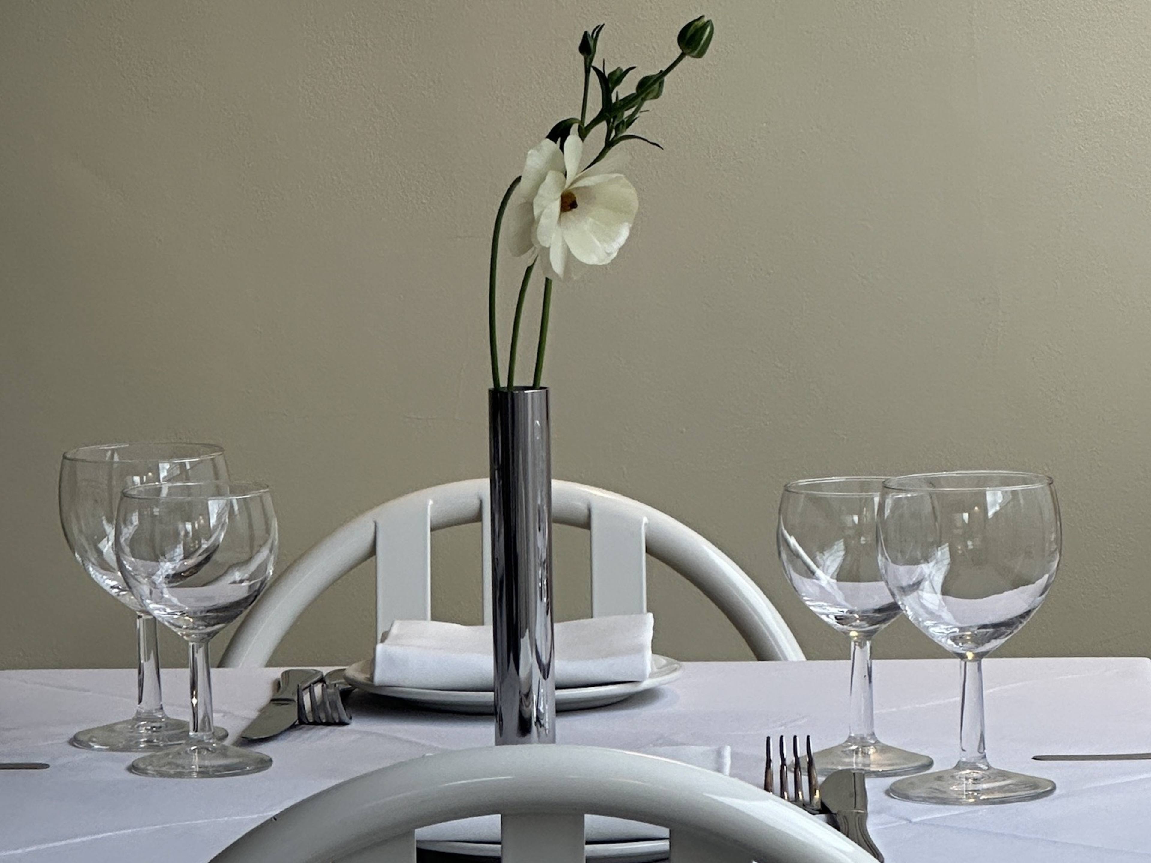 A table with a mid-century flower holder on it from Dalla in Hackney.