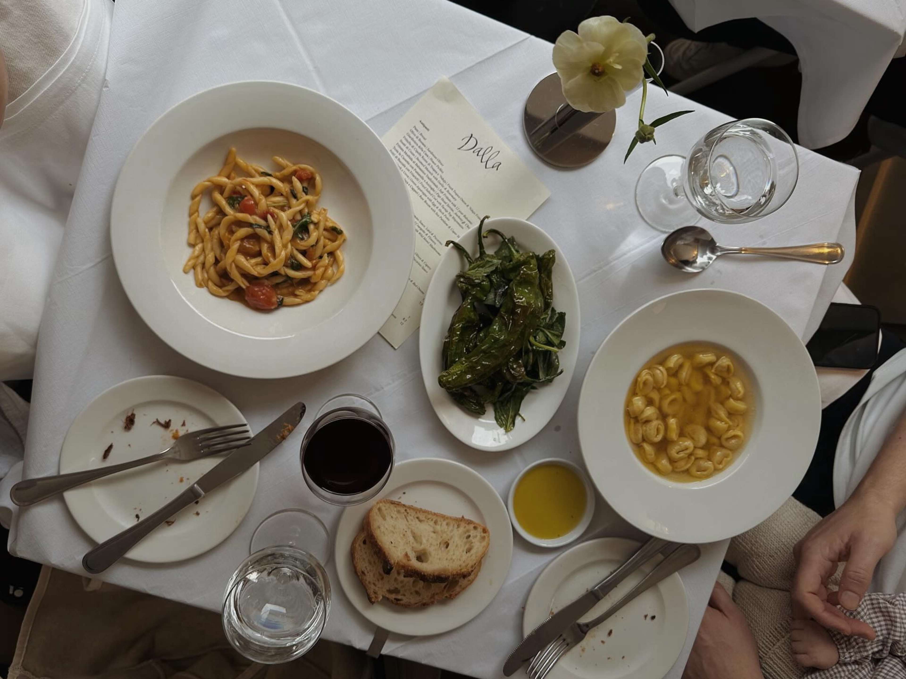 A table of brodo, pasta, charred peppers, and bread from Dalla in Hackney.