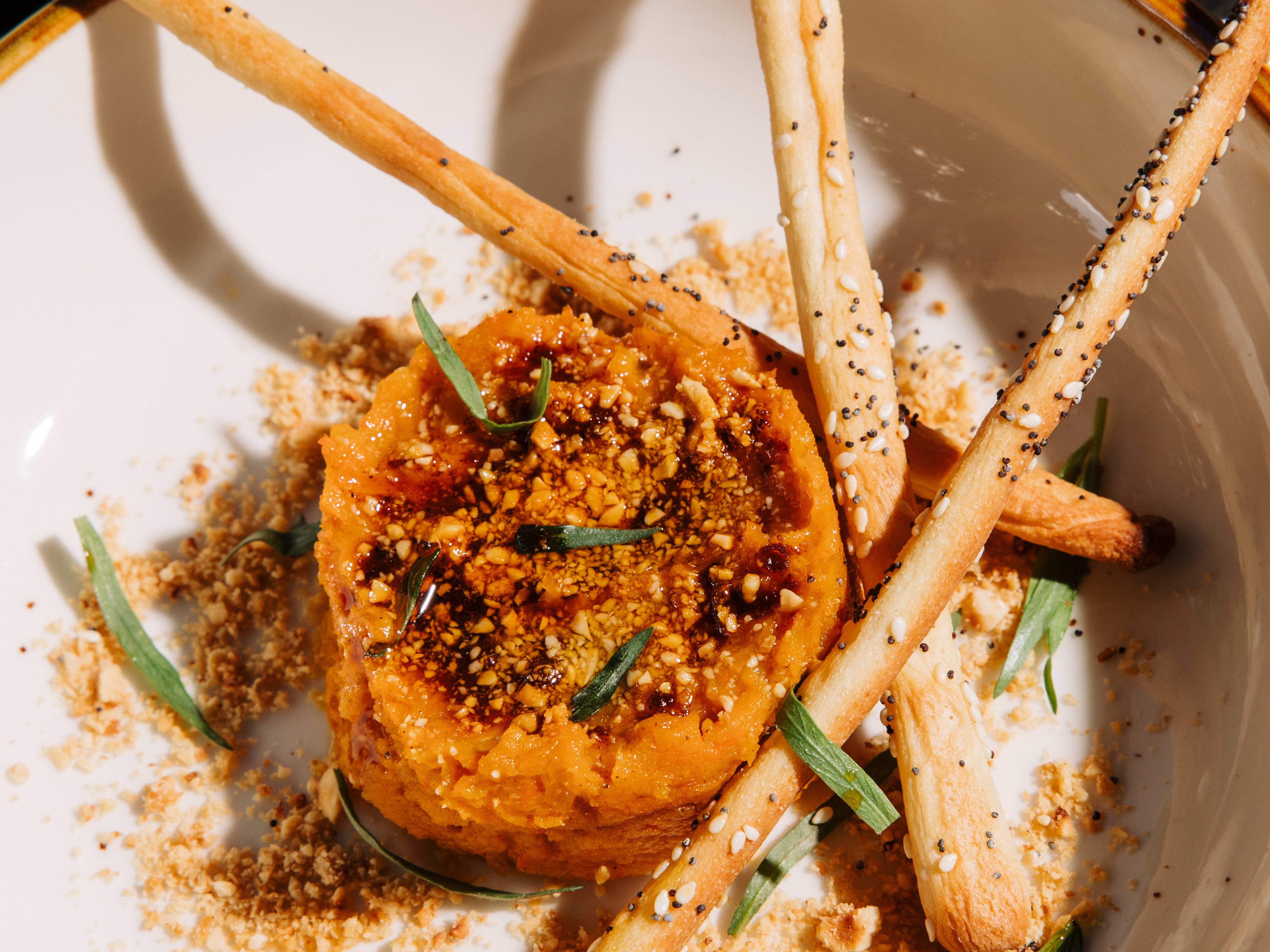 carrot tartare with crostinis and sprigs of tarragon