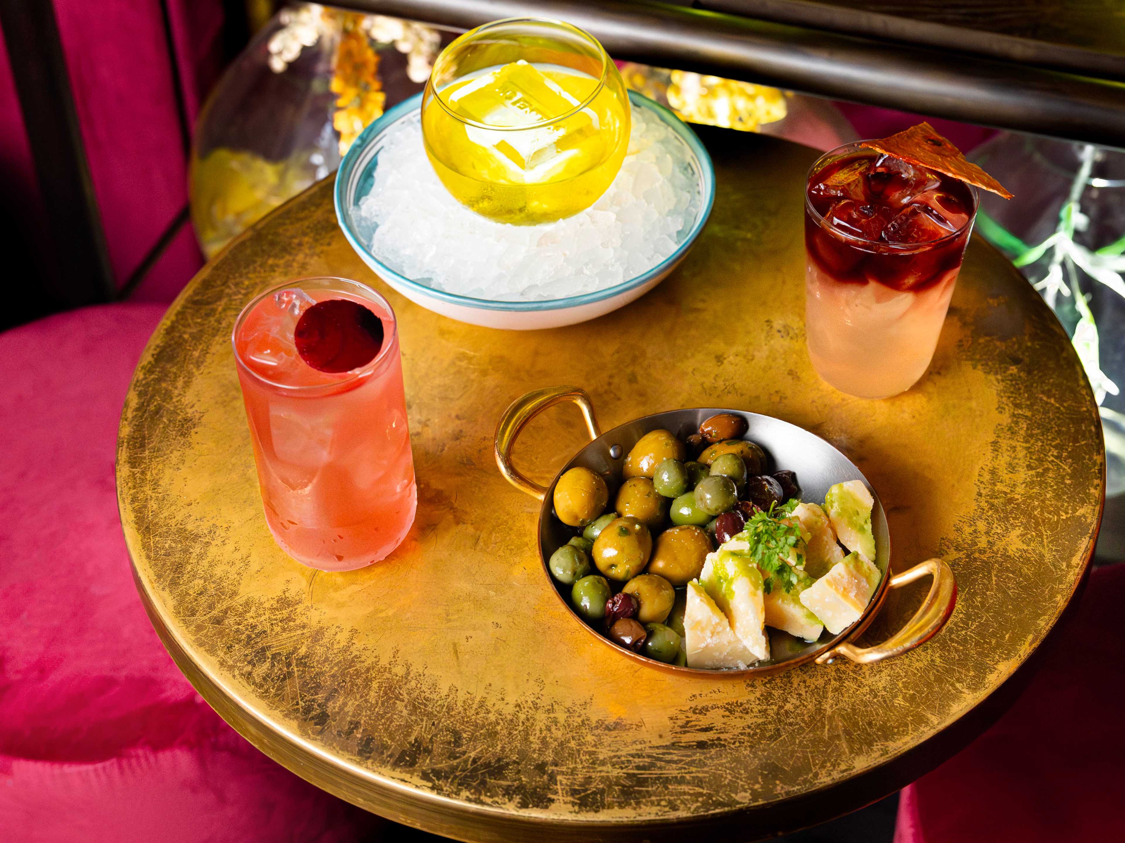 Spread of cocktails and an olive and cheese plate at No Entry