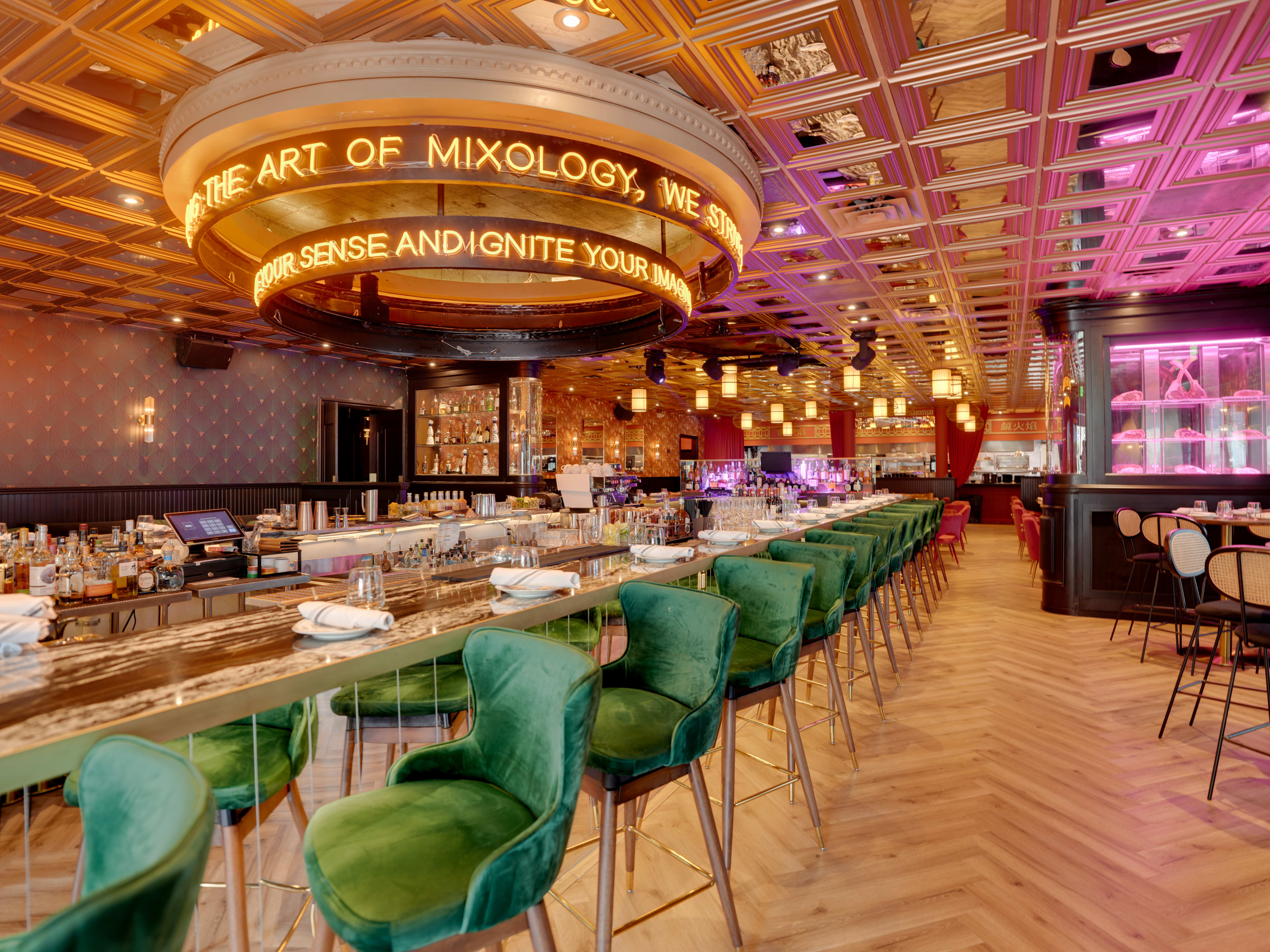 massive bar interior with neon signs and high ceilings