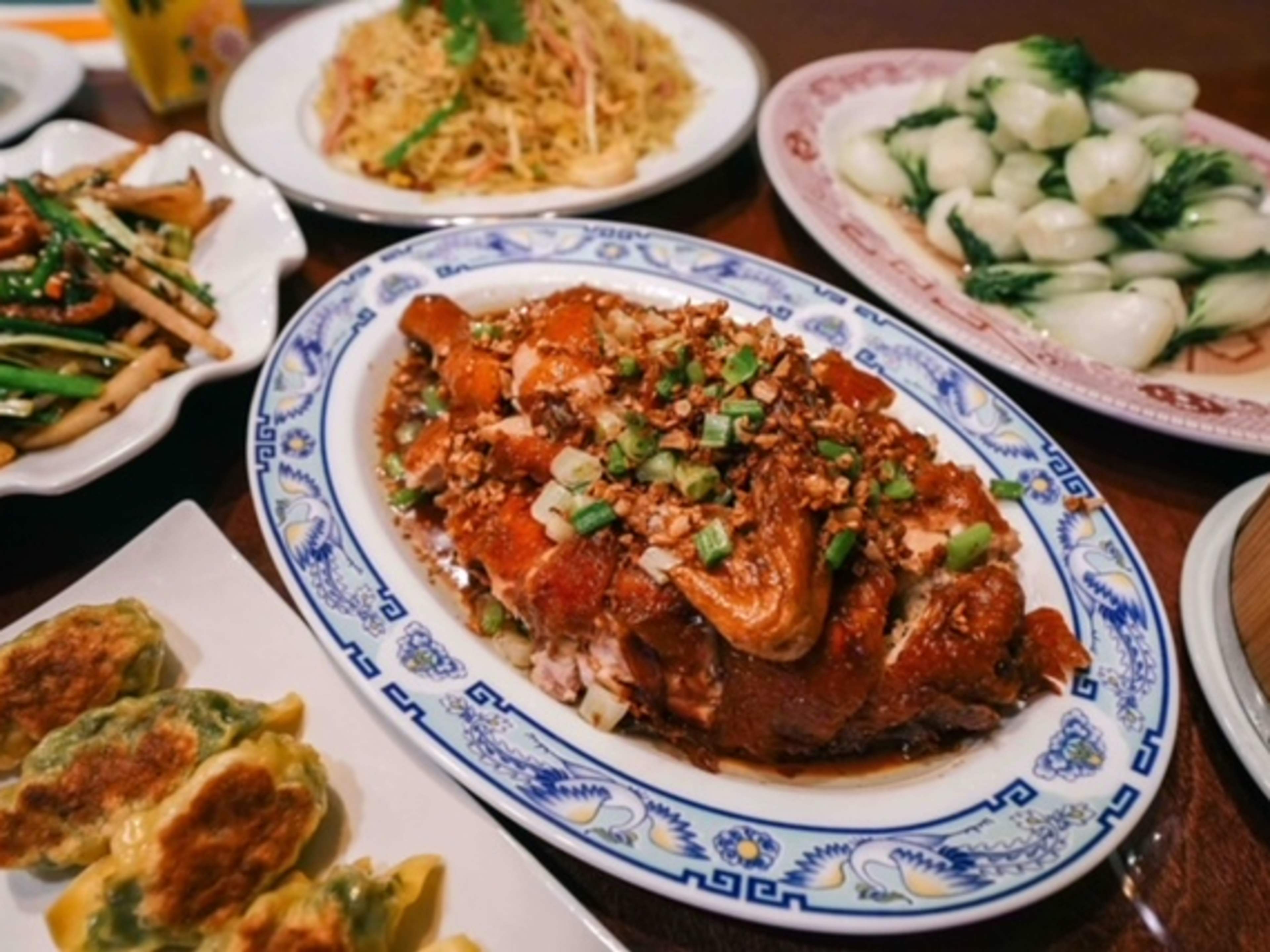 A spread of Cantonese food, with crispy chicken, dumplings, and rice cakes.