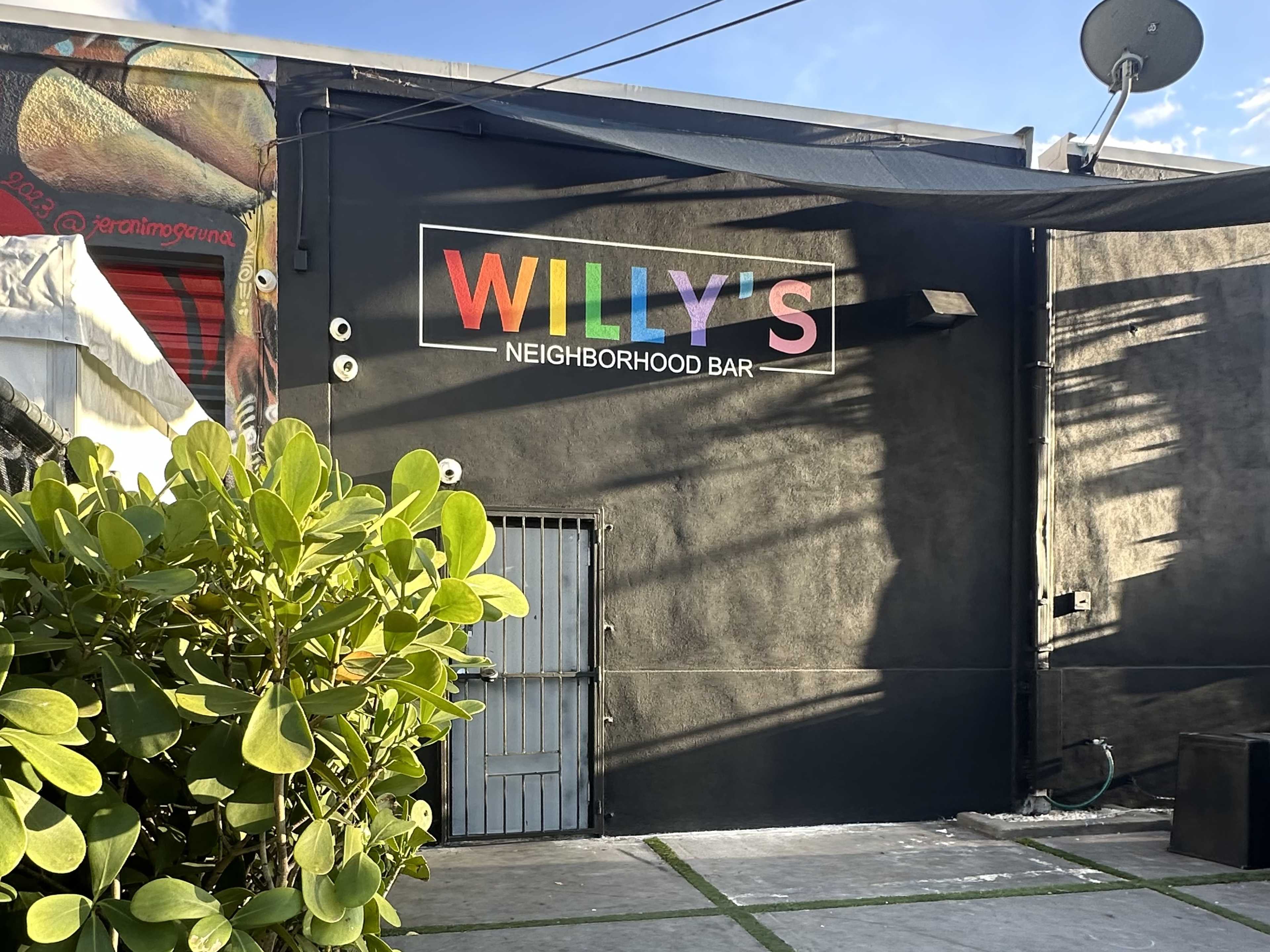 exterior of bar with rainbow lettering spelling out Willy's