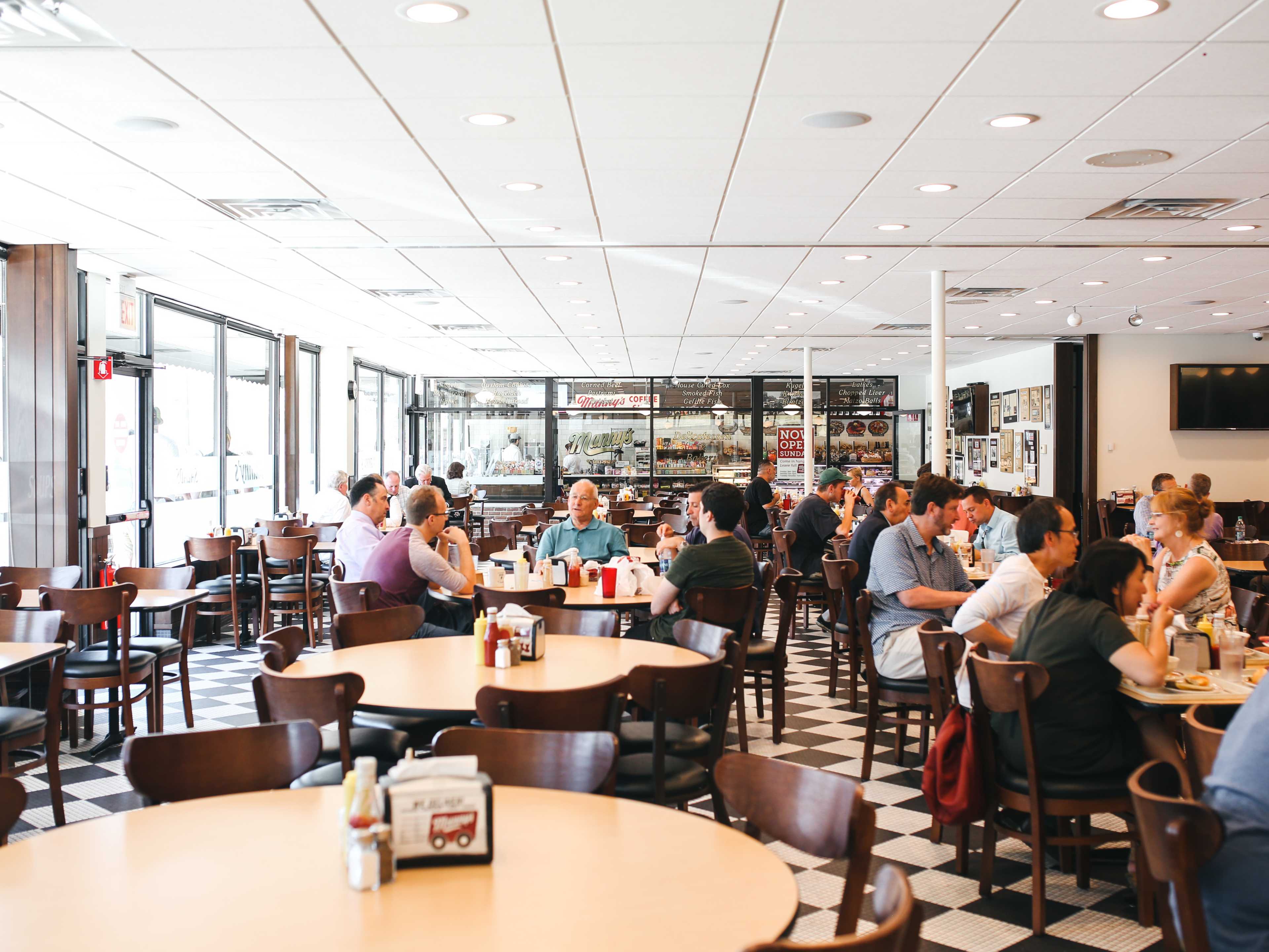 People dining at tables at Manny’s.