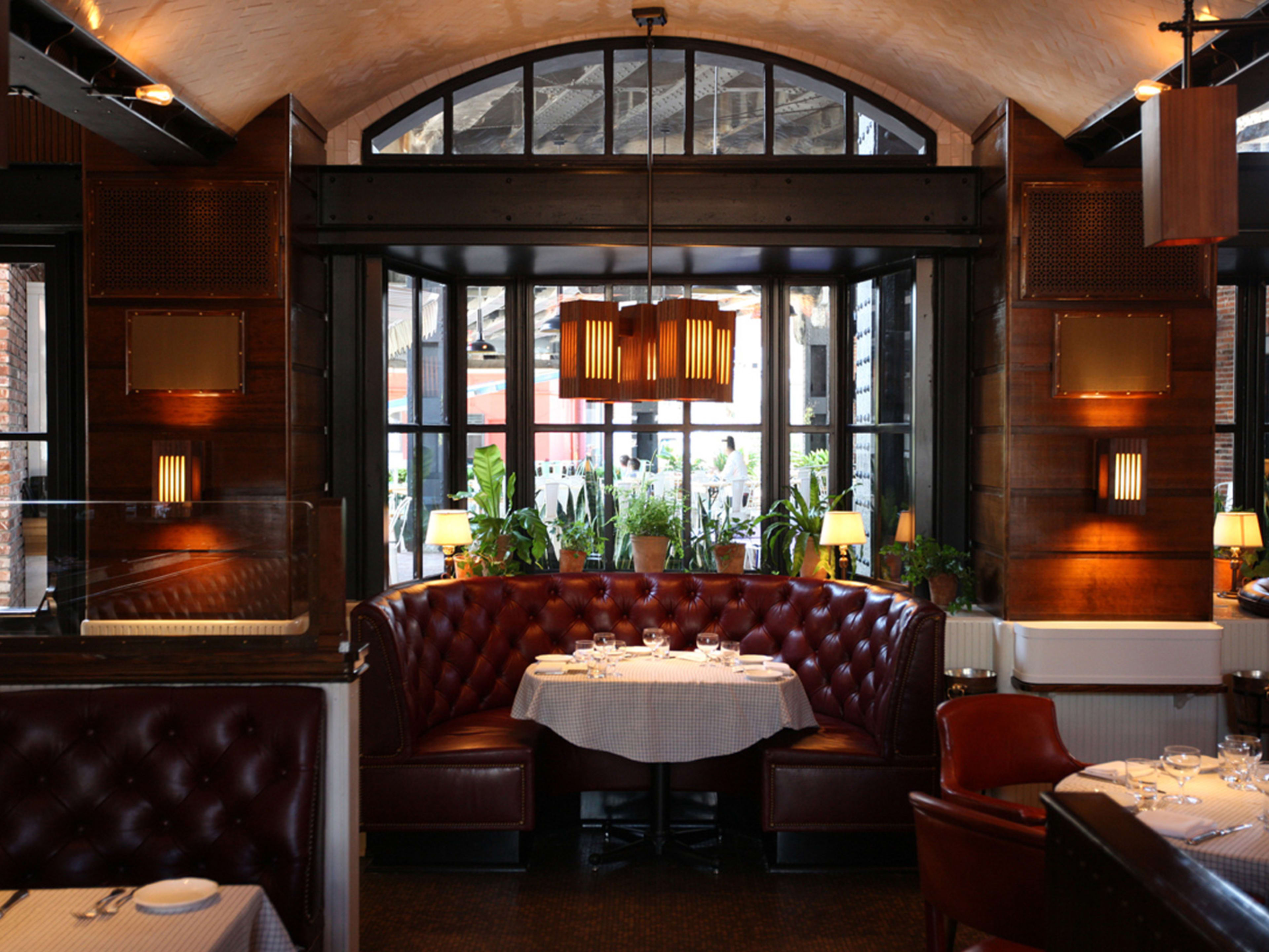 A maroon leather banquet booth inside the dining room at The Standard Grill.