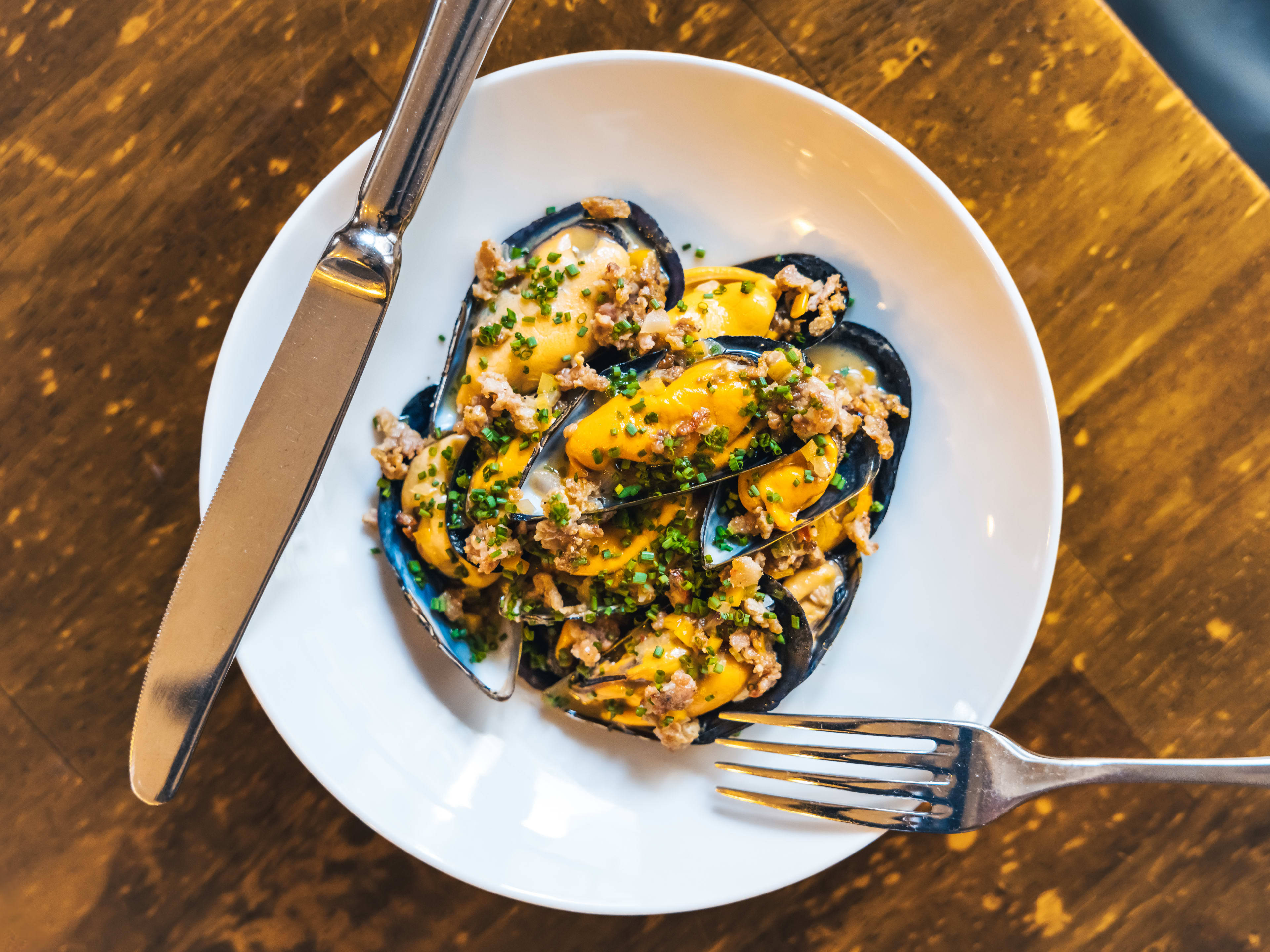 Mussel dish topped with chives at Soces in Paris