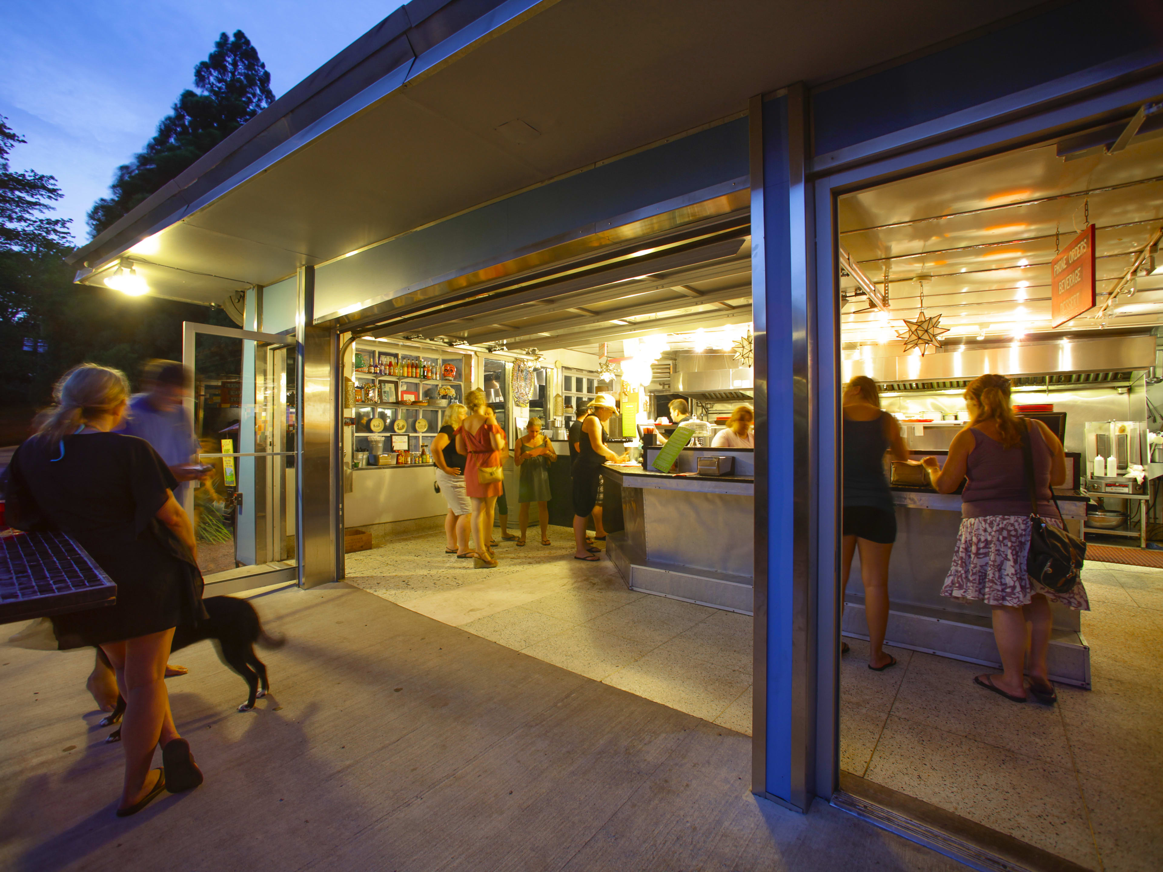 La Fondita exteriors with customers ordering from the counter and the walls open to the outdoor dining area