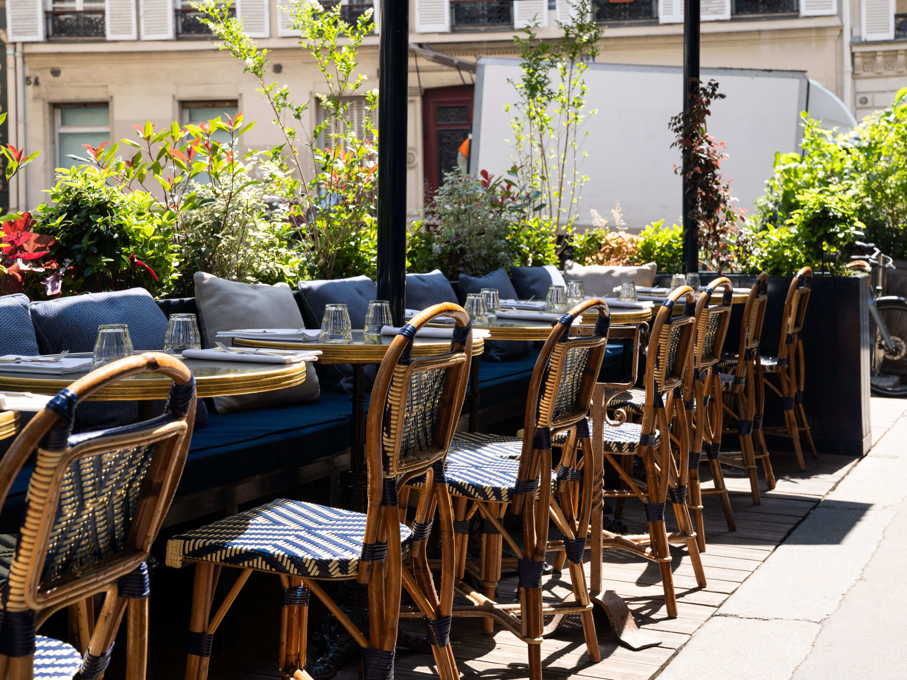 Exterior dining area with blue cushions at Le Bon Georges