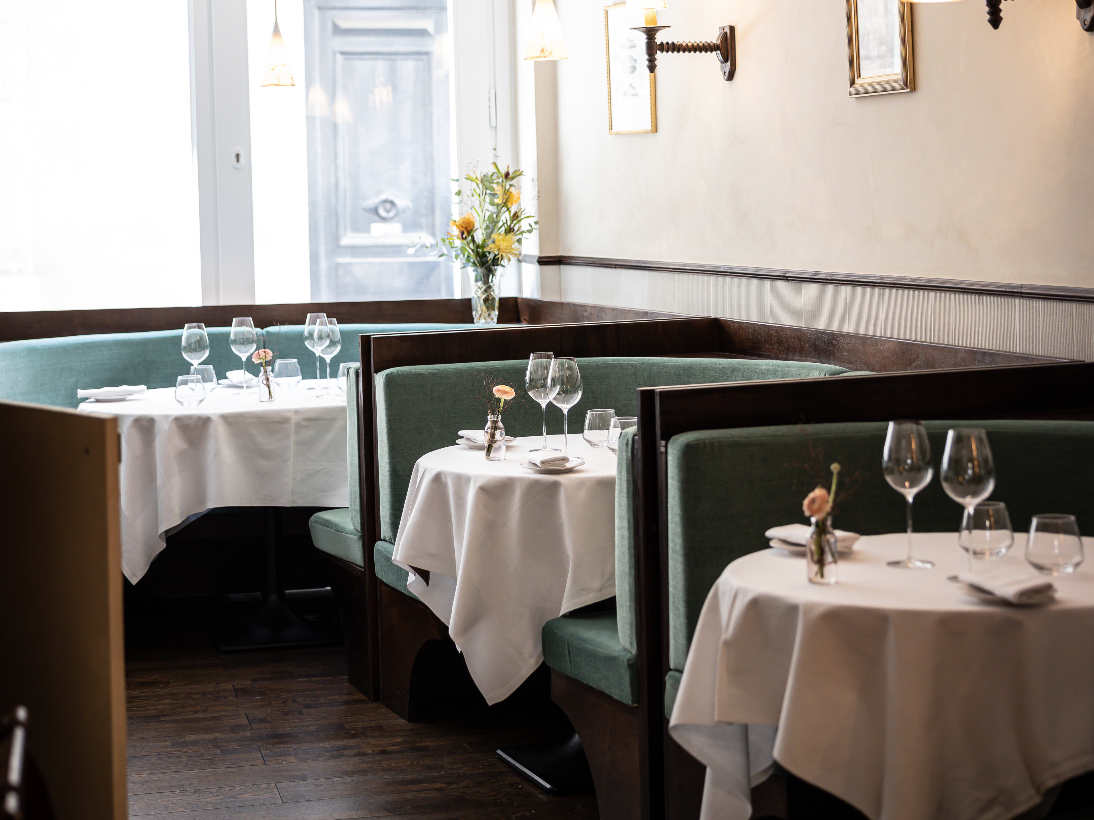 Bright interior with set tables and blue booths at Pantagruel