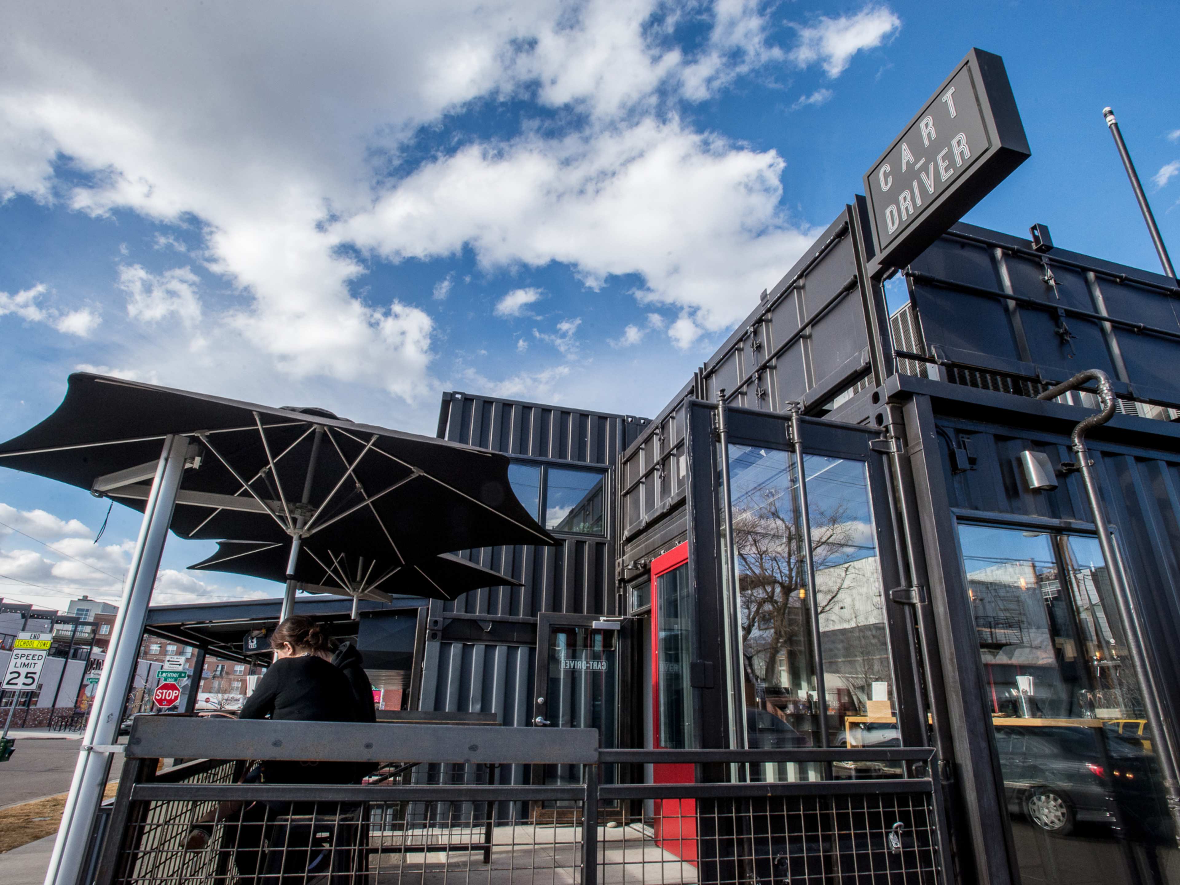 A black shipping container that has been converted into Cart-Driver.