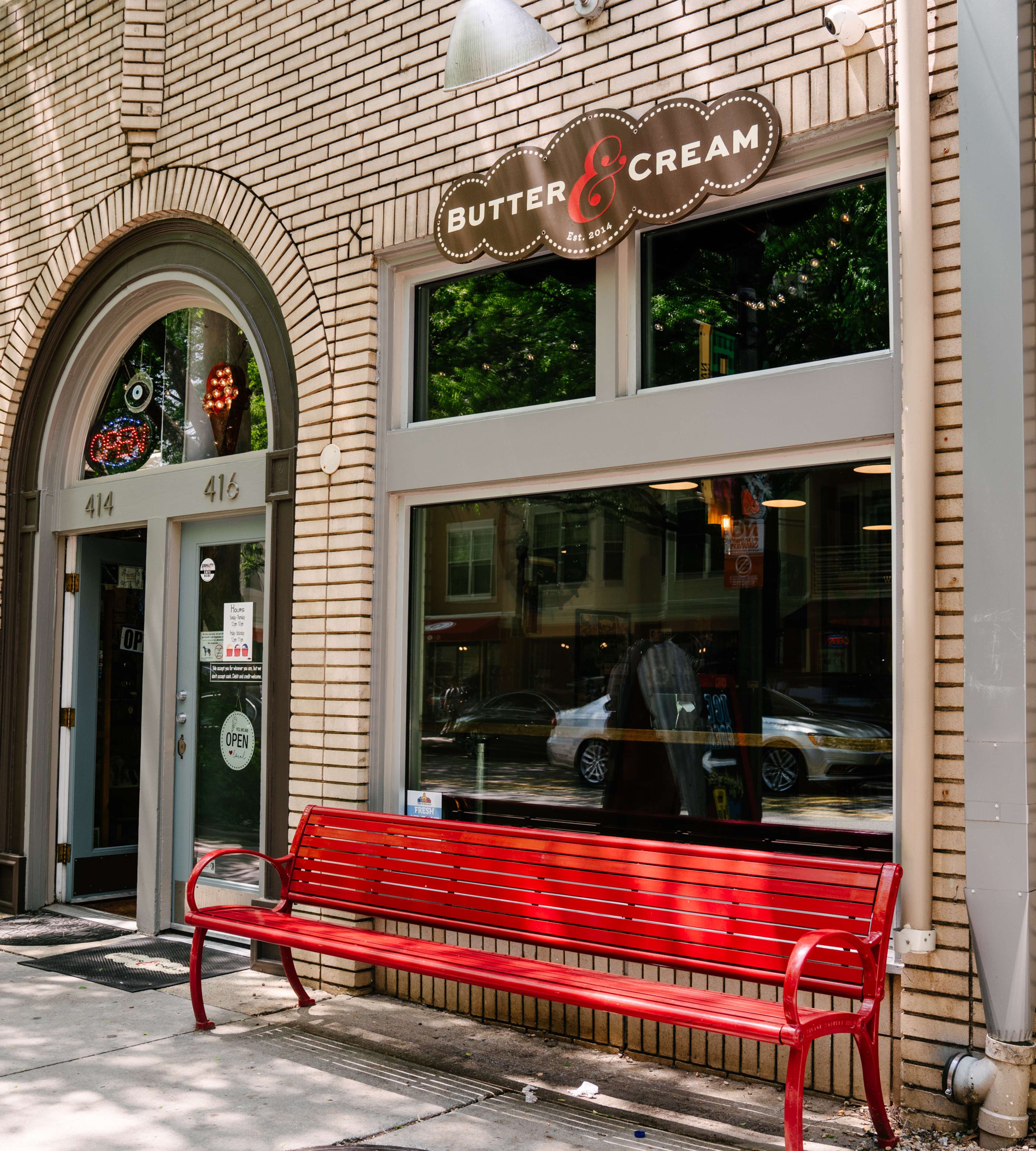 exterior of ice cream shop with red bench