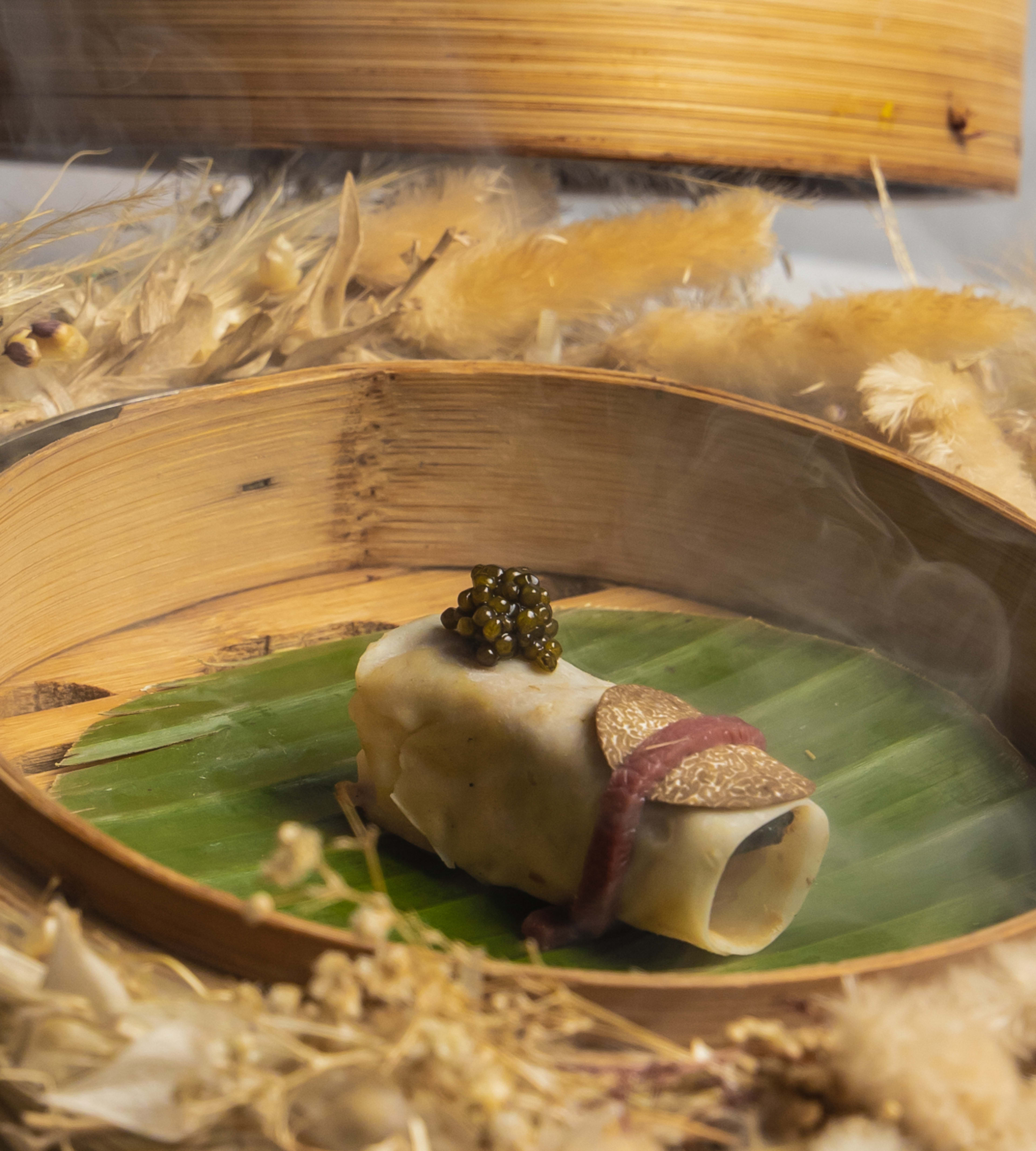 The 'memories of Peking duck' mini roll from A. Wong with a spoon of caviar on one end and a shaving of black truffle on the other.