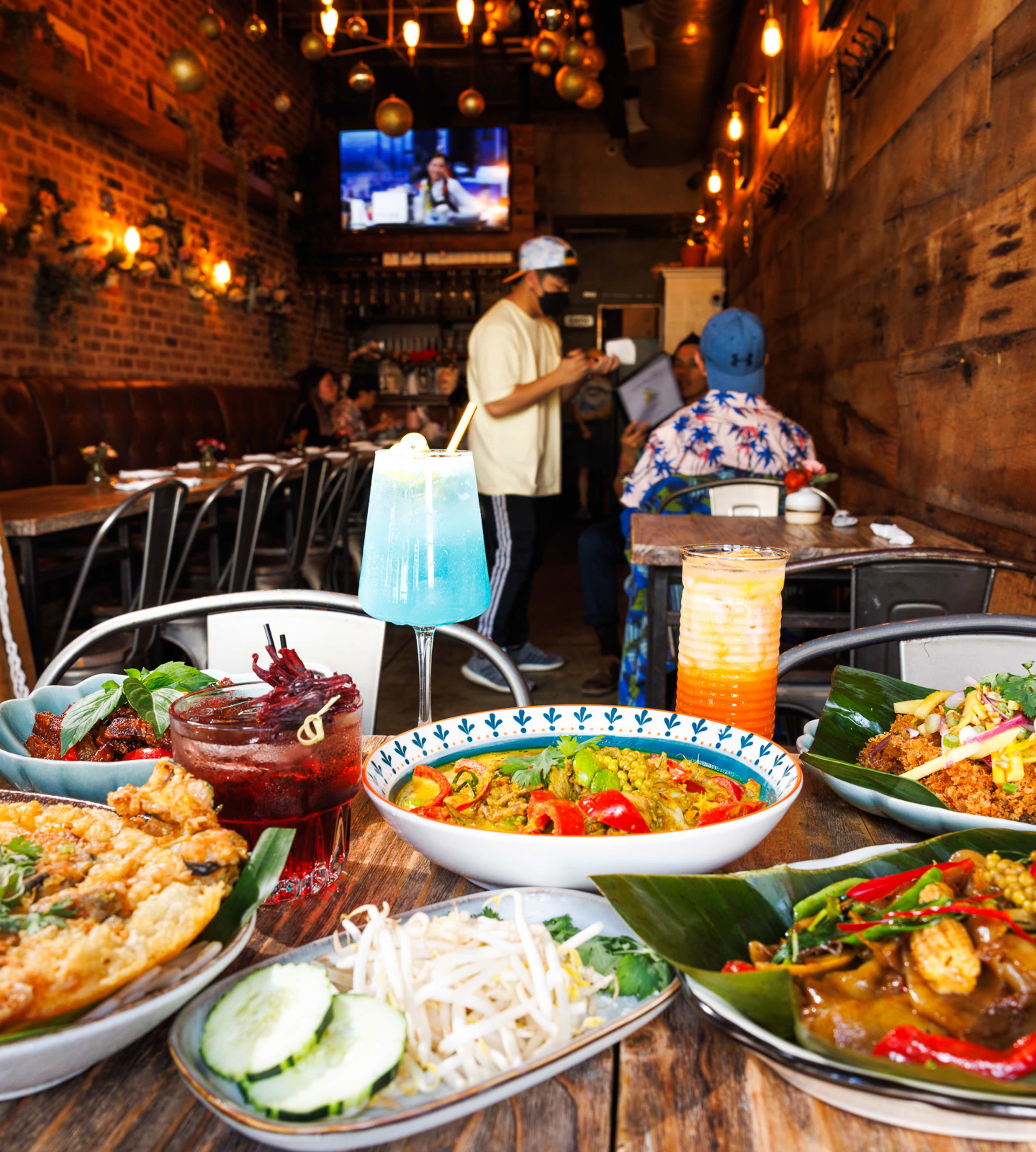 a spread of thai dishes and the interior at Saranrom Thai