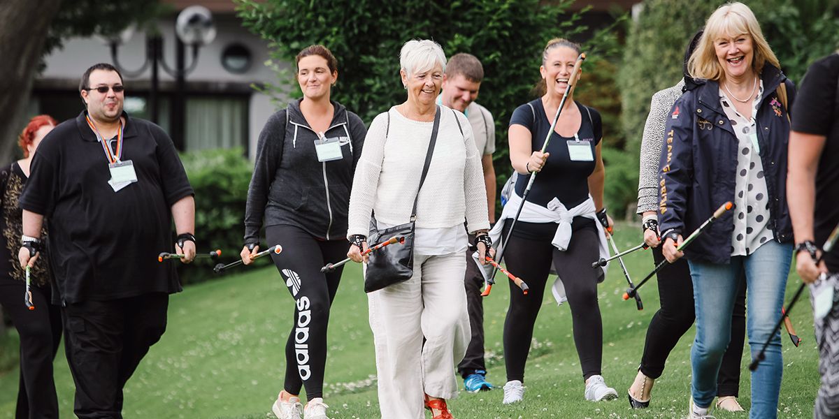 This is a picture of a group of office workers on an experience and team building day. They are using Nordic Walking Poles