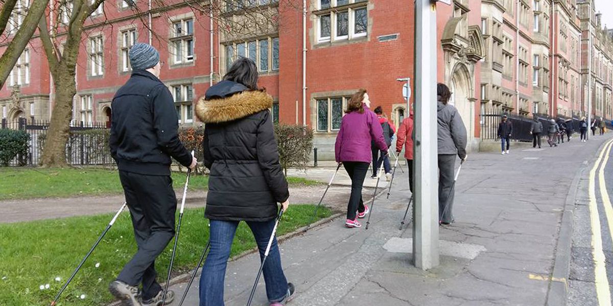 This is a picture of a group of office workers going for a walk around the UCLan buildings in Preston. They are using Nordic Walking Poles