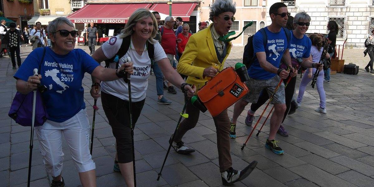 This is a picture of a group of Nordic Walkers on a charity event in Italy. One of the walkers in the middle is in Fancy Dress. Matt Gibbs is walking next to him