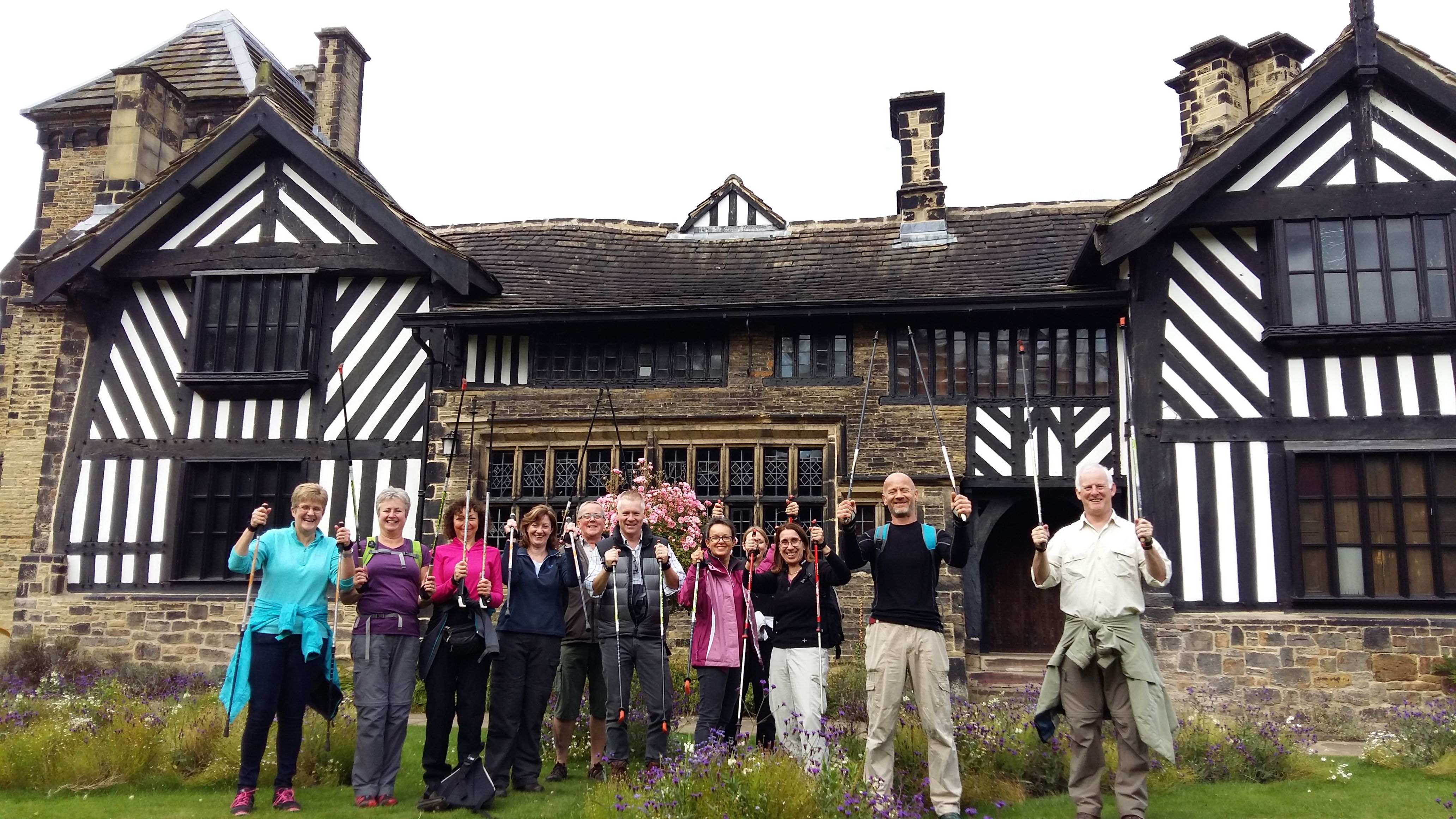 The image shows a group of Nordic Walkers outside of Shibden Hall