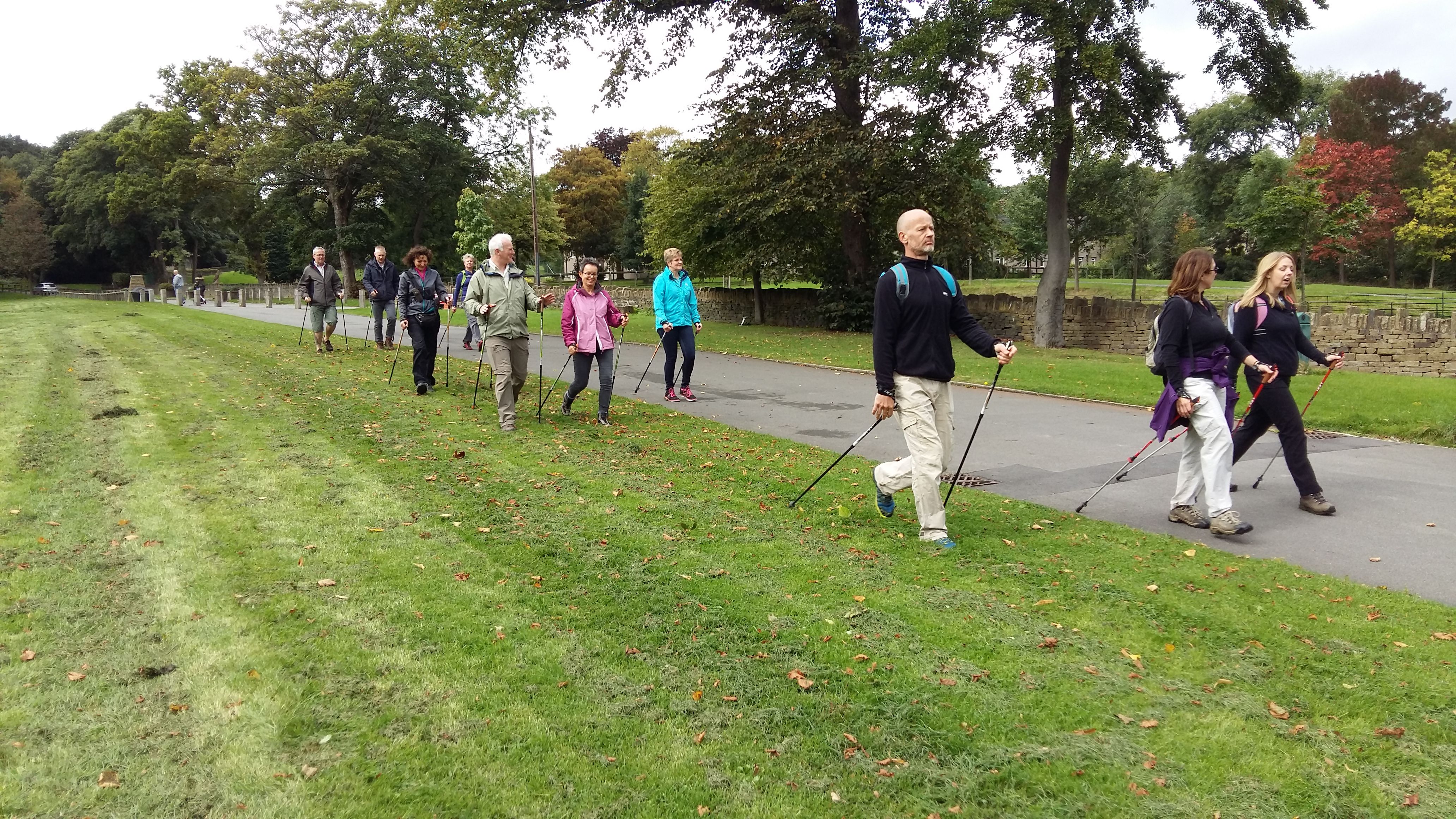 The image shows a group of Nordic Walkers in the grounds of Shibden Hall