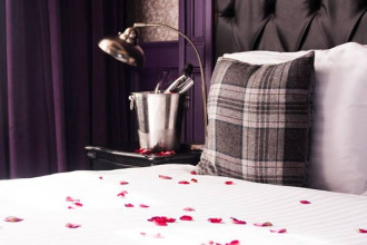 Bed with scattered rose petals