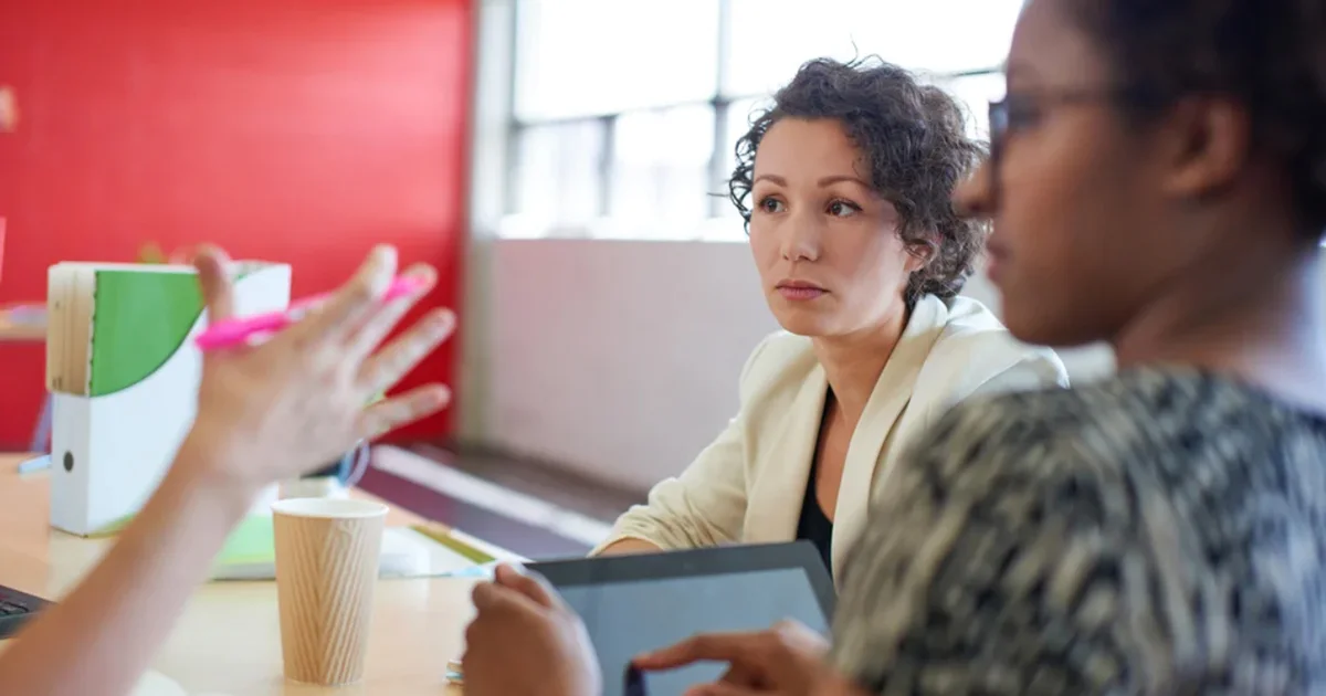 Three women having a discussion.
