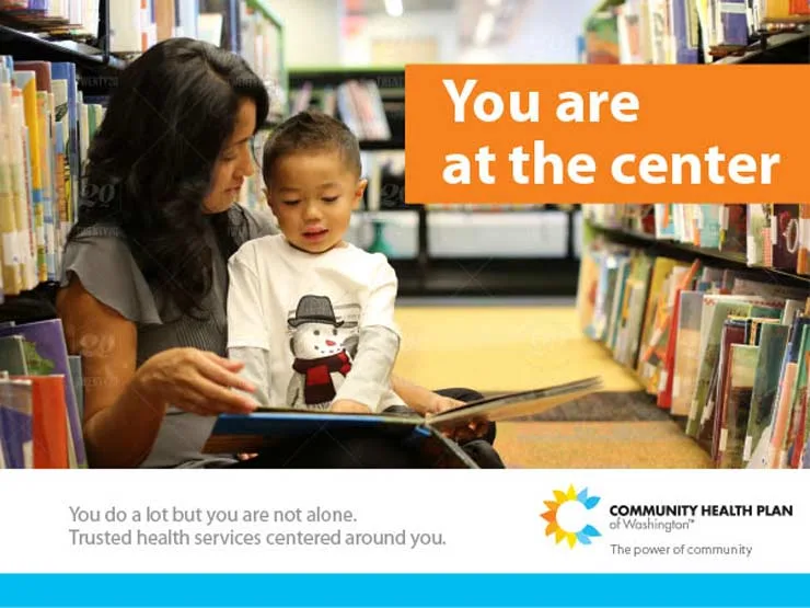 Infant boy sitting on women's lap up against a bookshelf on the library floor reading a book with text You are at the center. And text below You do a lot but you are not alone. Trusted health services centered around you. And Community Health Plan of Washington logo on the bottom right.