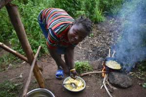 The Water Project:  Lady Preparing Potatoes For Her Family