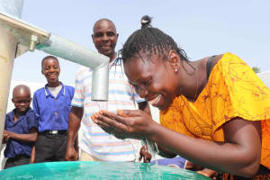 The Water Project:  Teacher Joyfully Drinking
