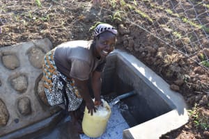 The Water Project: Mukangu Community, Werabukaya Spring -  Fetching Water