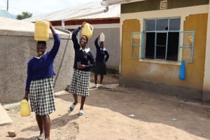 The Water Project: Ikoli Primary School 2 -  Children Carrying Water