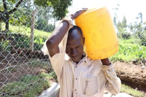 The Water Project:  Pius Carrying Water