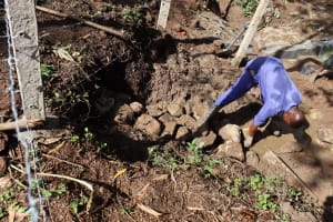 The Water Project: Shianda Community 11 -  Backfilling With Large Rocks
