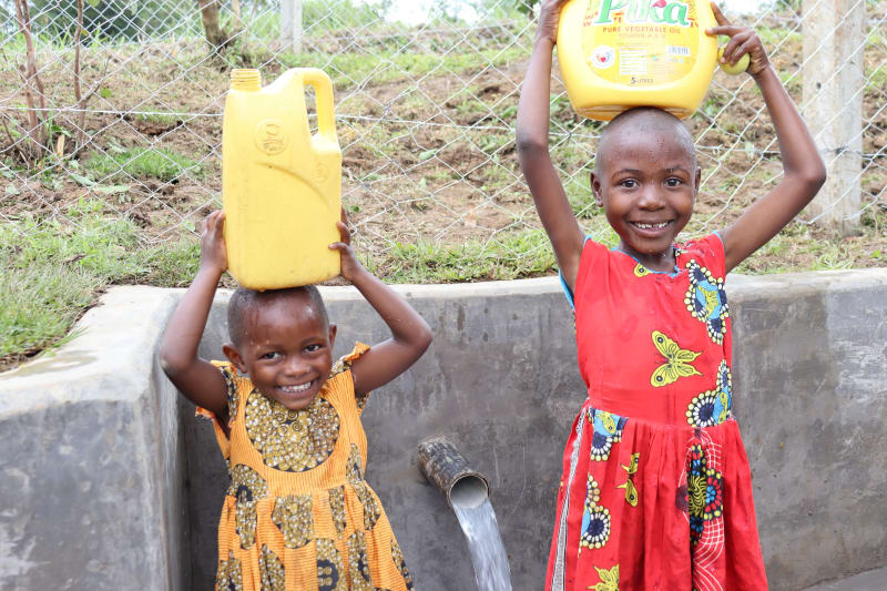 Children collecting water from a protected spring.