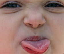 Cheeky child sticking tongue out