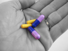 A hand holding pills