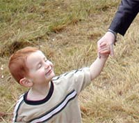 A kid looking up at his mum