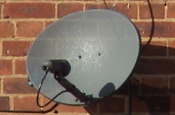 A satellite dish mounted on a wall