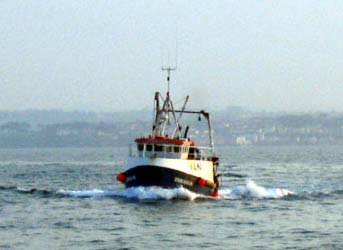 A trawler coming home after a day of fishing