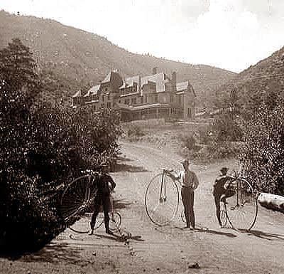 ordinary-bicycles-manitou-springs-colorado three bike riders stand next to their high wheel ordinarys