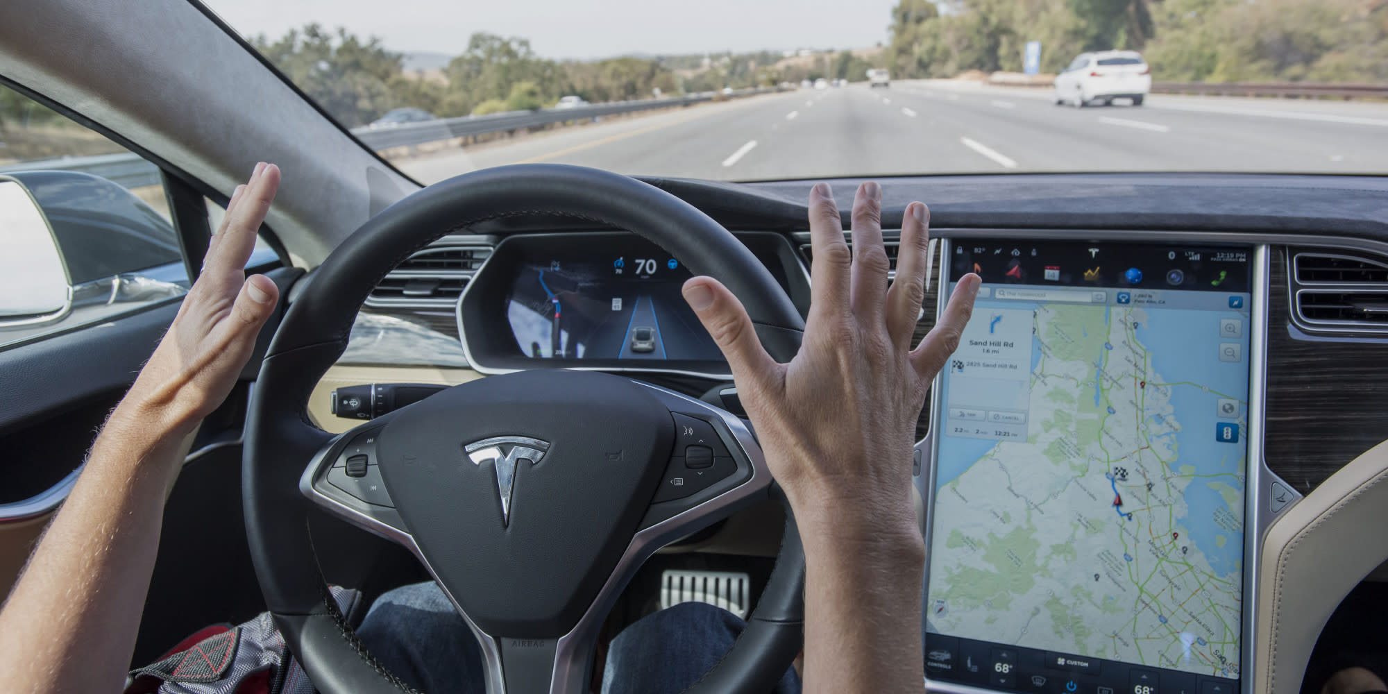 A member of the media test drives a Tesla Model S equipped with Autopilot in Palo Alto, California, U.S., on Wednesday, Oct. 14, 2015.