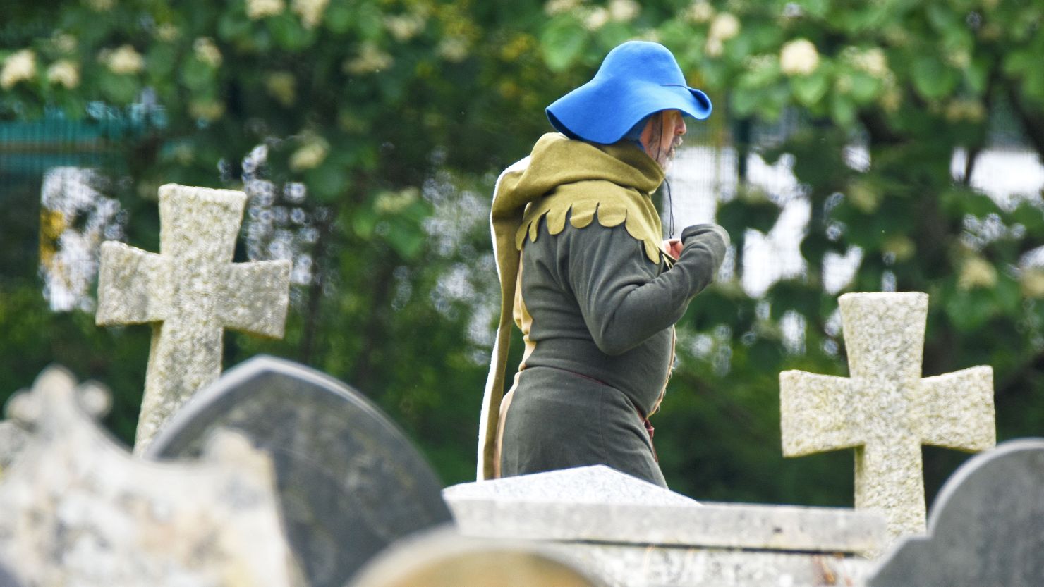 Man in medieval costume in a church yard