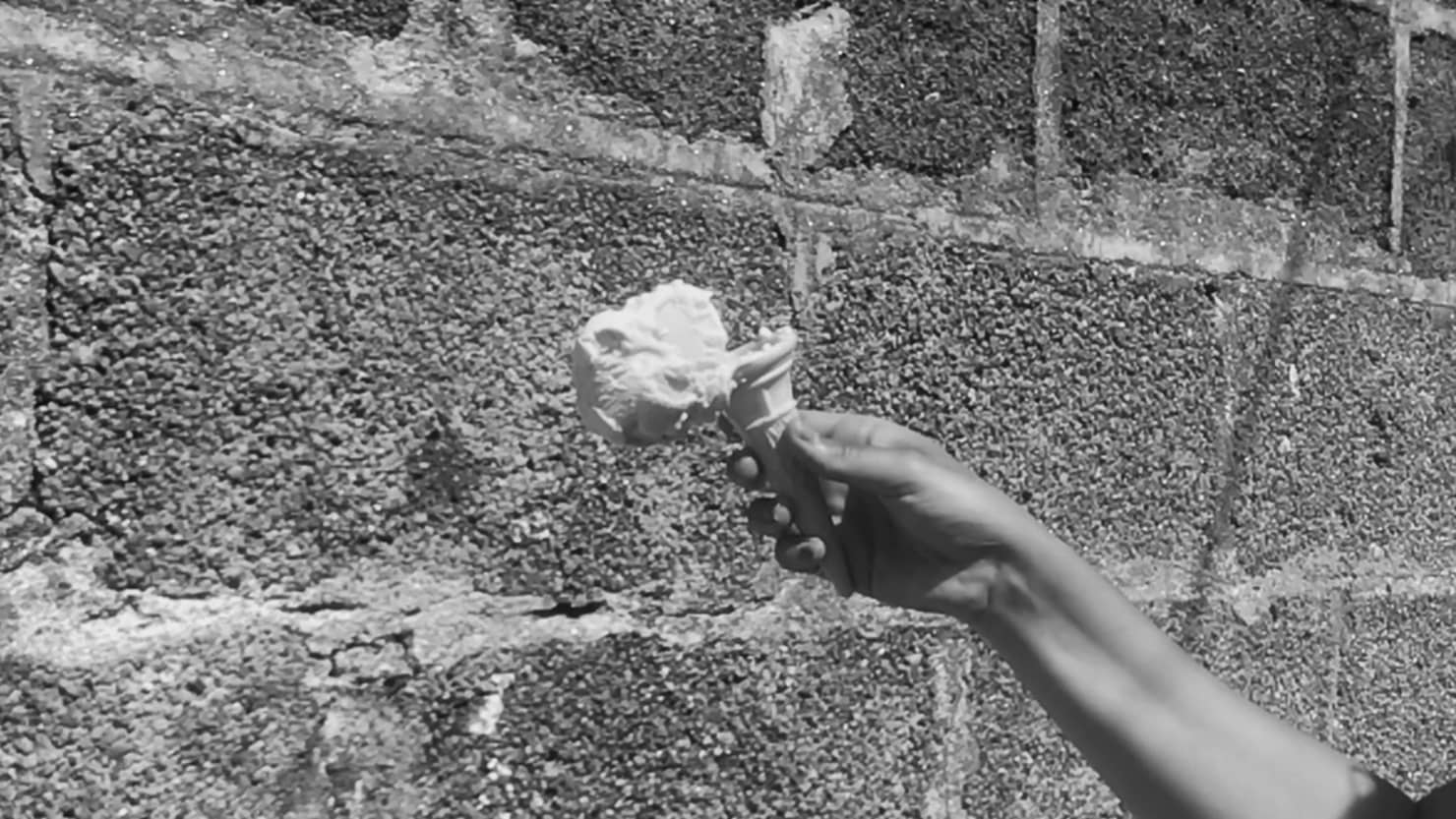 A still from Grace Lightman's music commission featuring an ice cream just about to hit a wall
