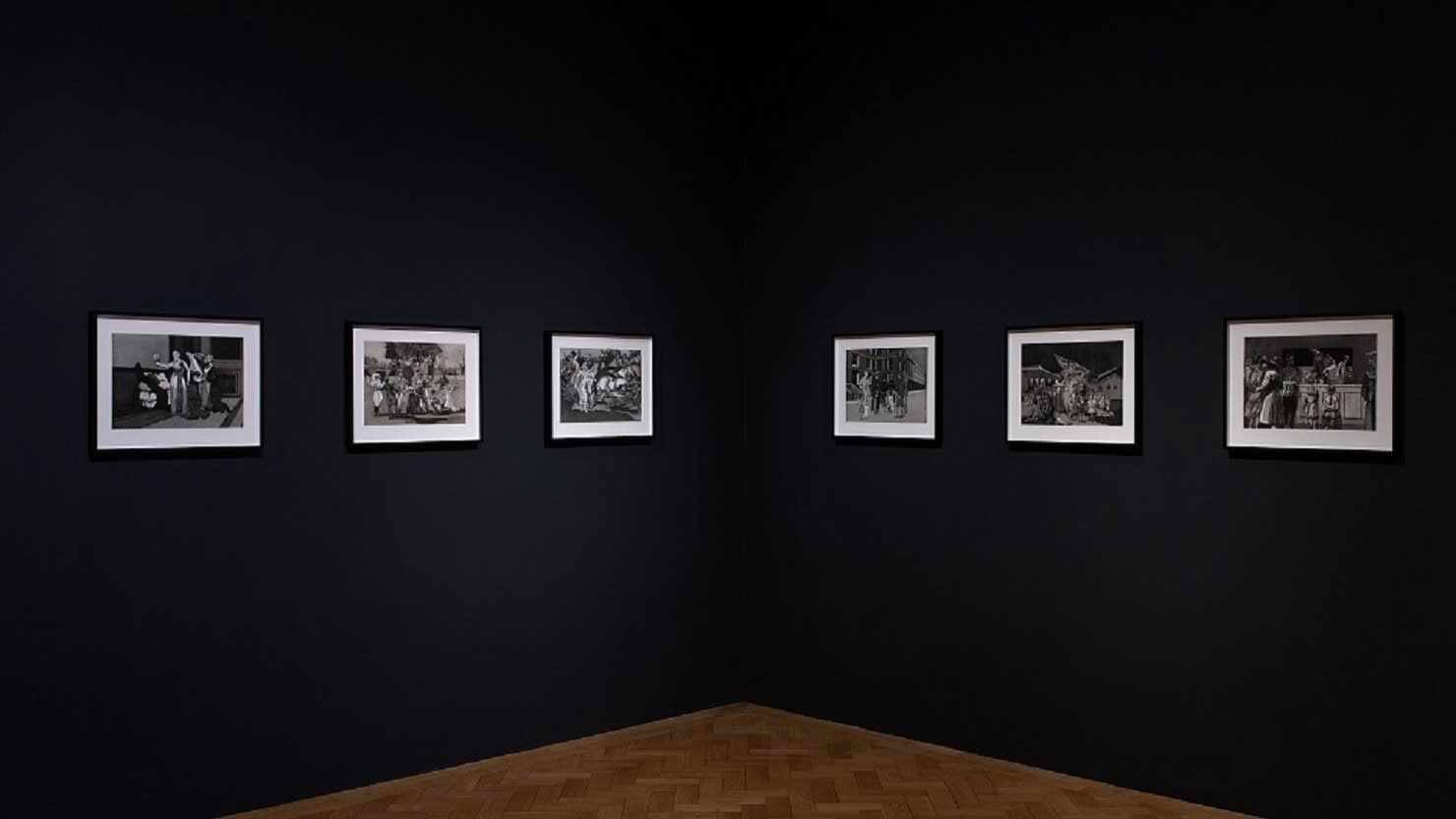 Drawings by artist duo Quinlan and Hastings on a black gallery wall