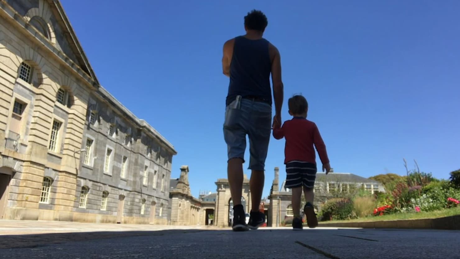 Andy Quick walking through the Royal William Yard with his young son