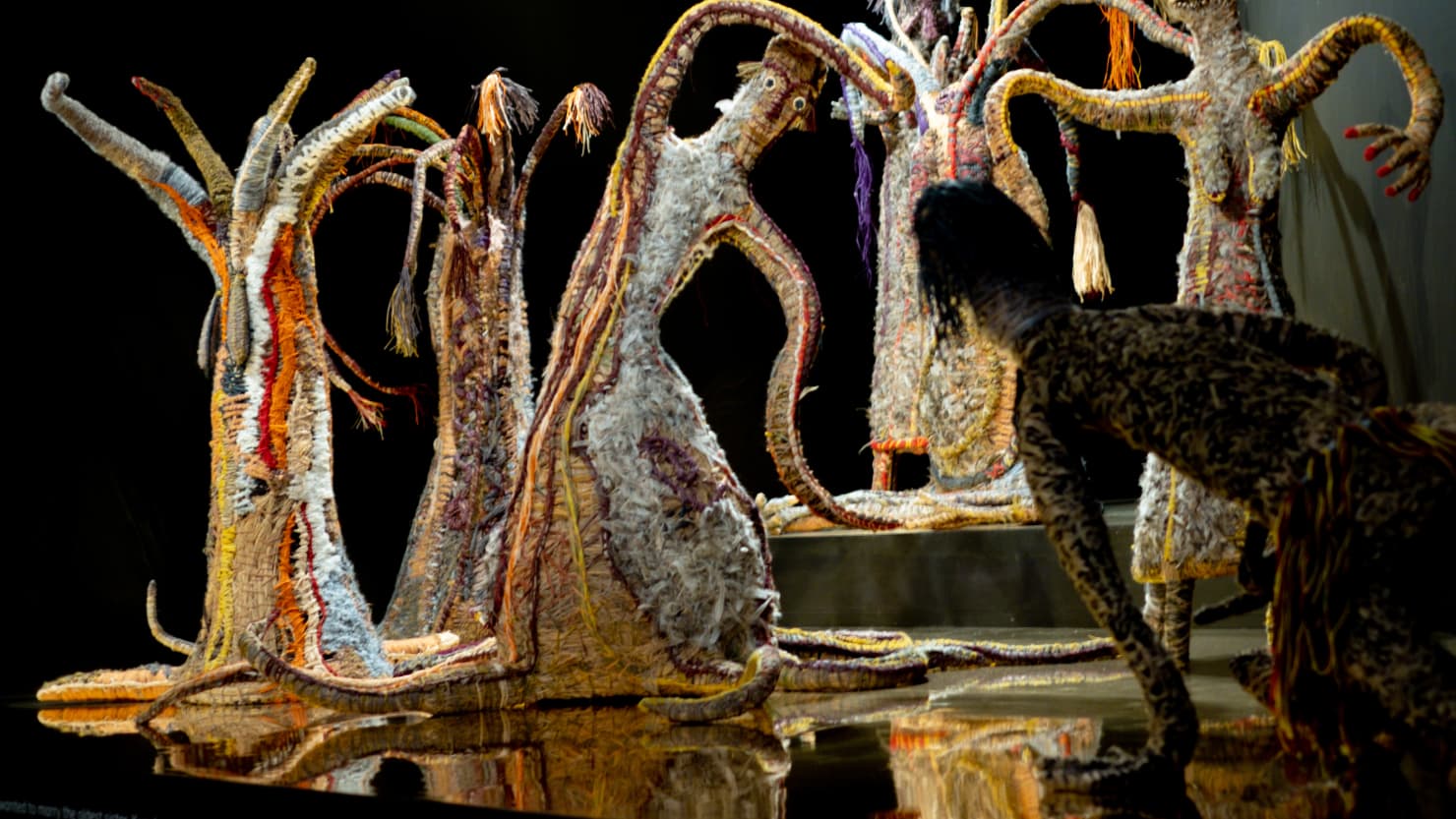 Woven women sculptures in the shape of trees