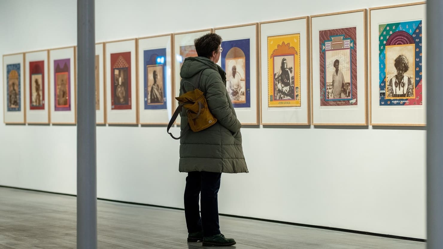 Visitor looking at A Few South Africans by Sue Williamson at The Box in Plymouth in 2023